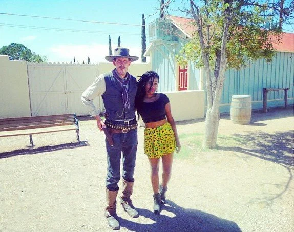 Visitor posing with OK Corral reenactment performer in Tombstone, Arizona