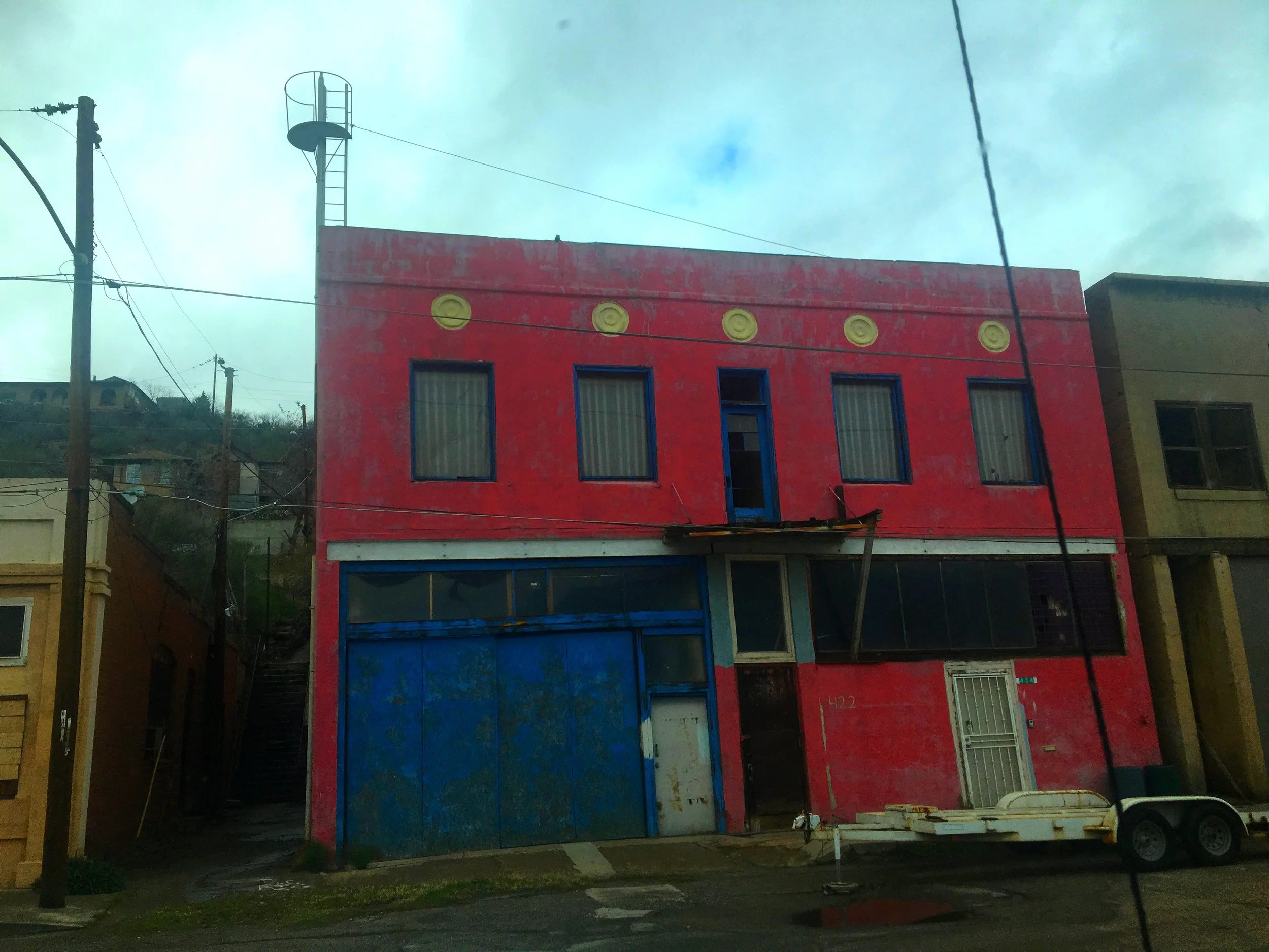 An old historic pink and blue building in Miami, Arizona.