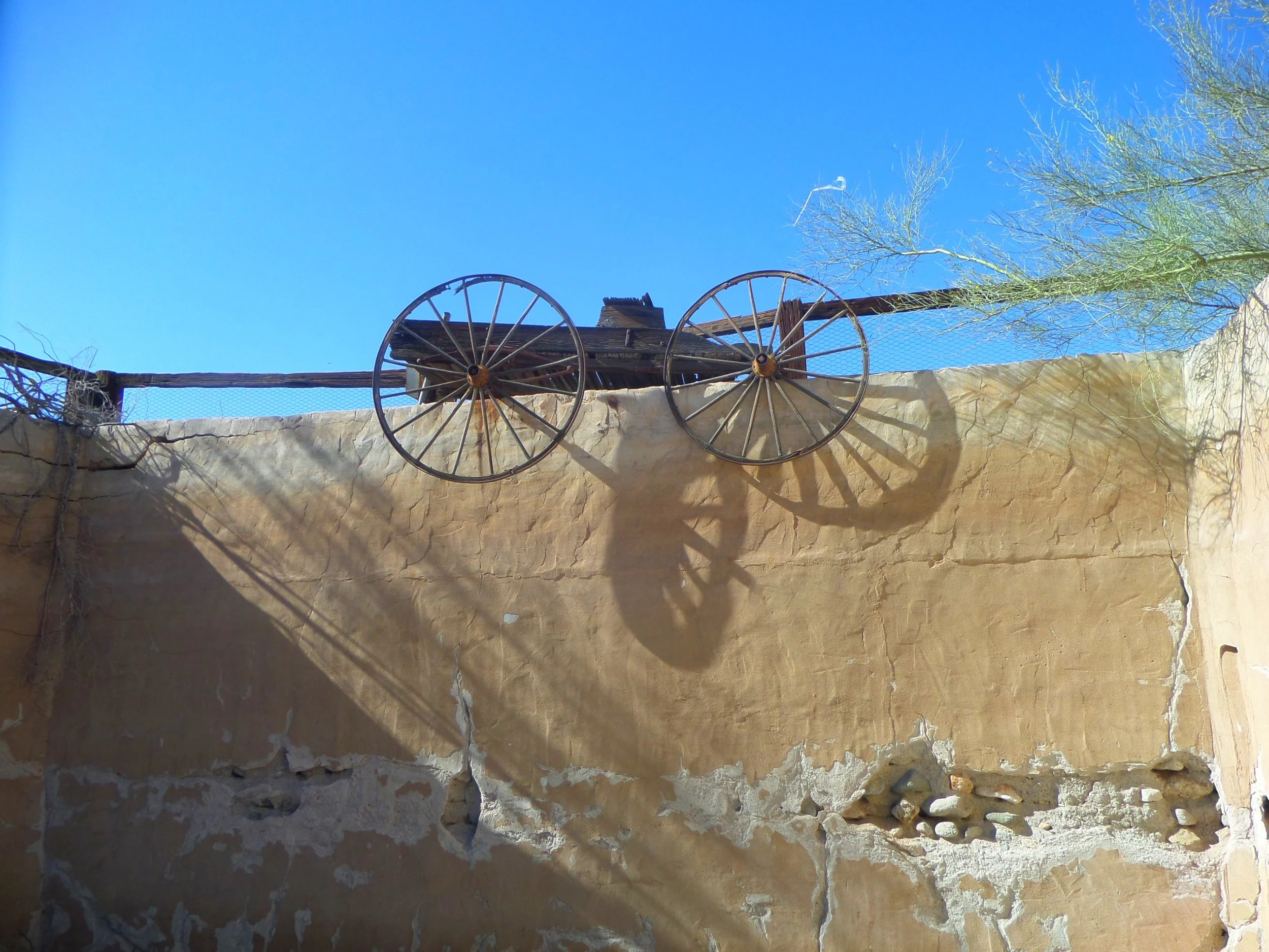 wagon-wheels-adobe-wall-desert-center.JPG