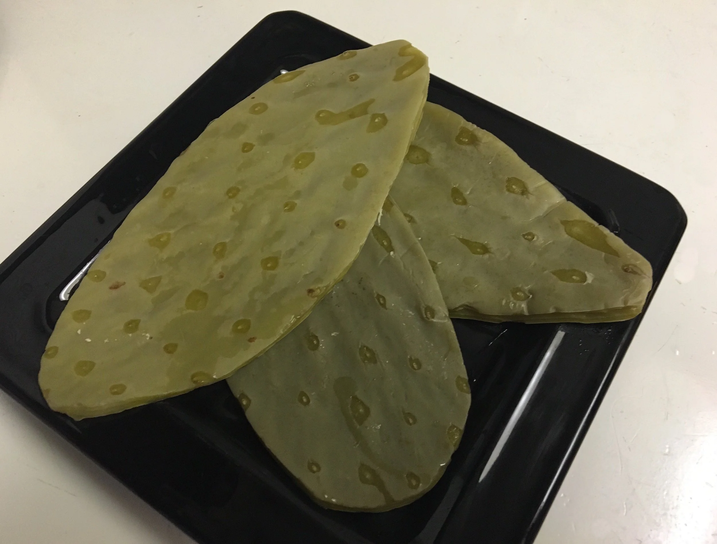 Raw nopal cactus paddle cleaned and trimmed before being used in traditional Southwestern and Mexican dishes.