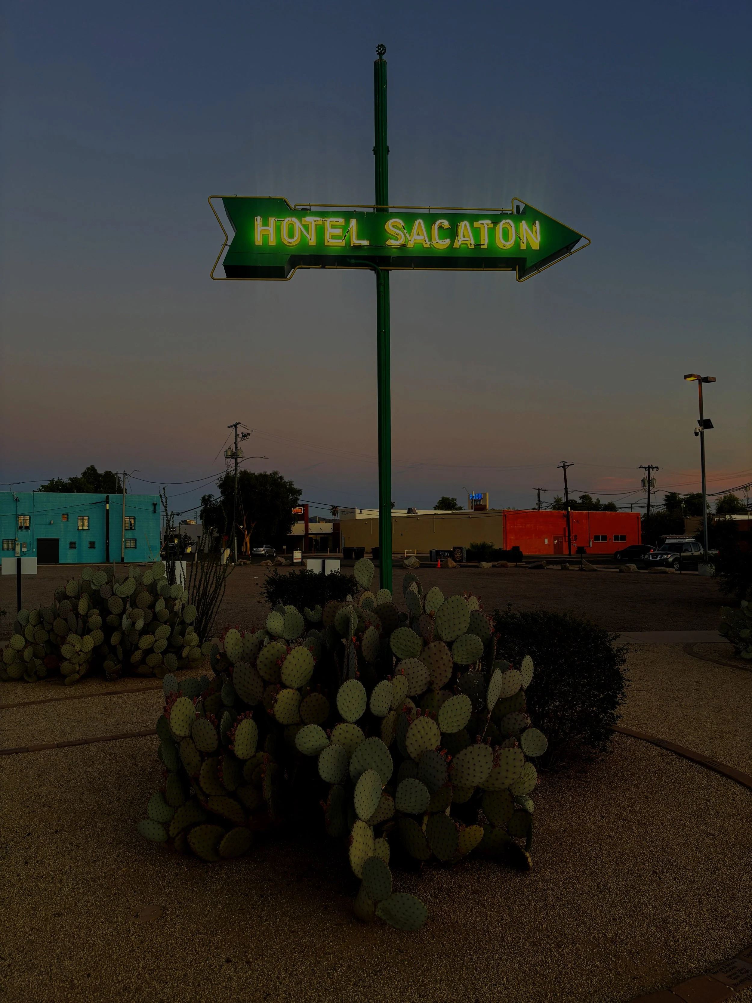 Restored vintage Hotel Sacaton neon sign illuminated at night at the Casa Grande Neon Sign Park in Casa Grande, Arizona.