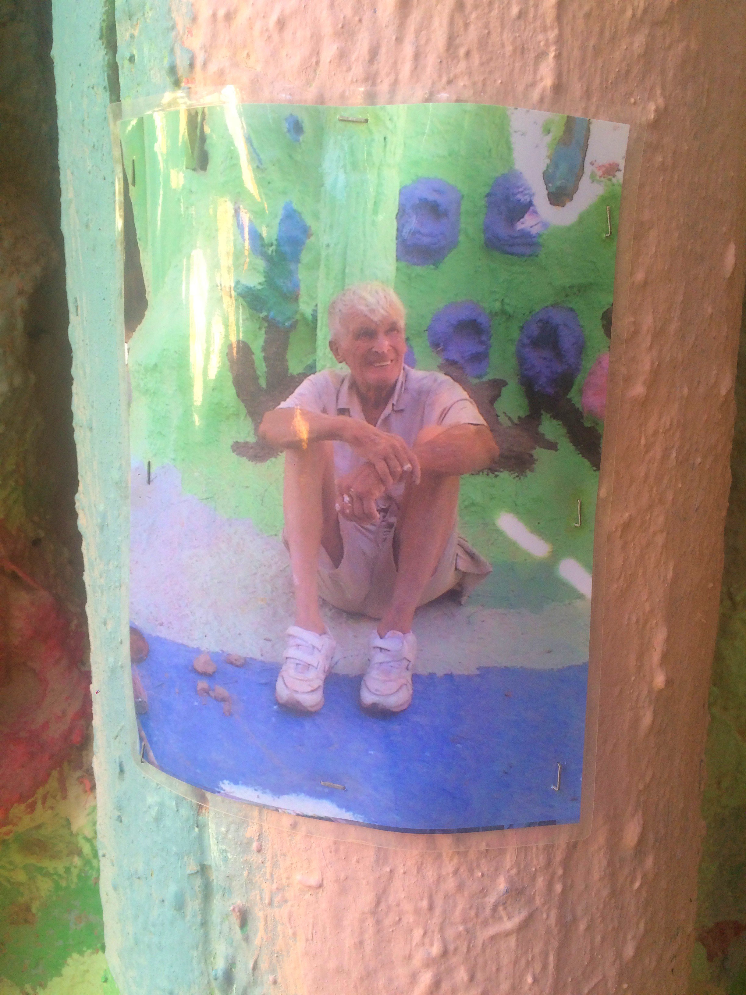 Photograph of Salvation Mountain creator Leonard Knight displayed inside the colorful desert art installation.