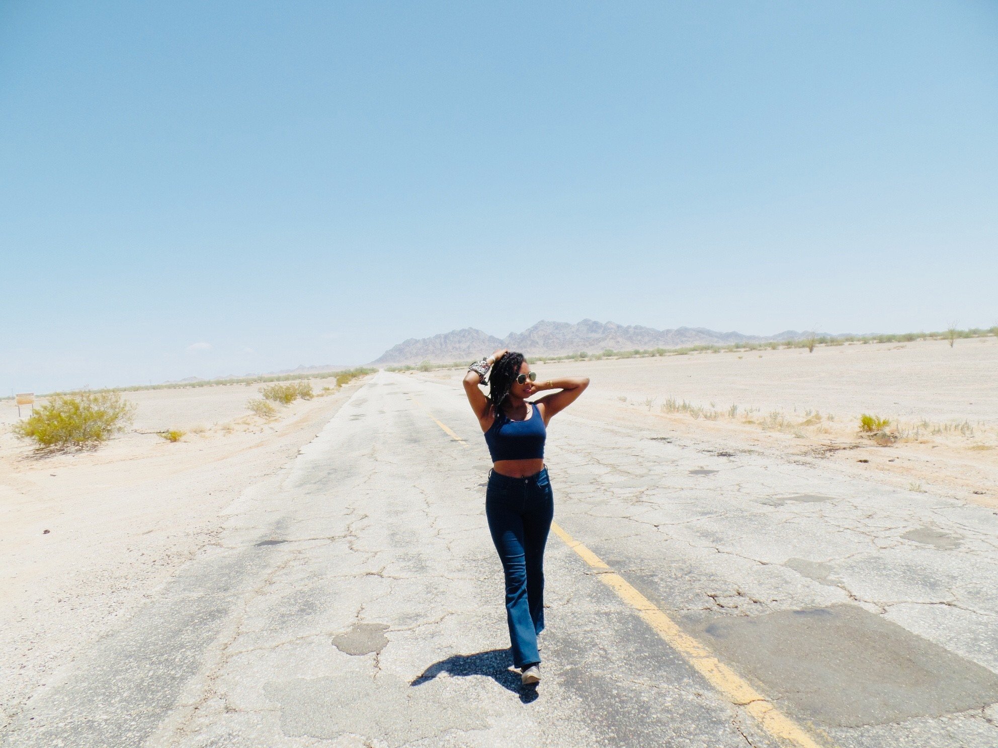 Author standing beside a remote desert highway near the Yuma borderlands in the Southwest desert.