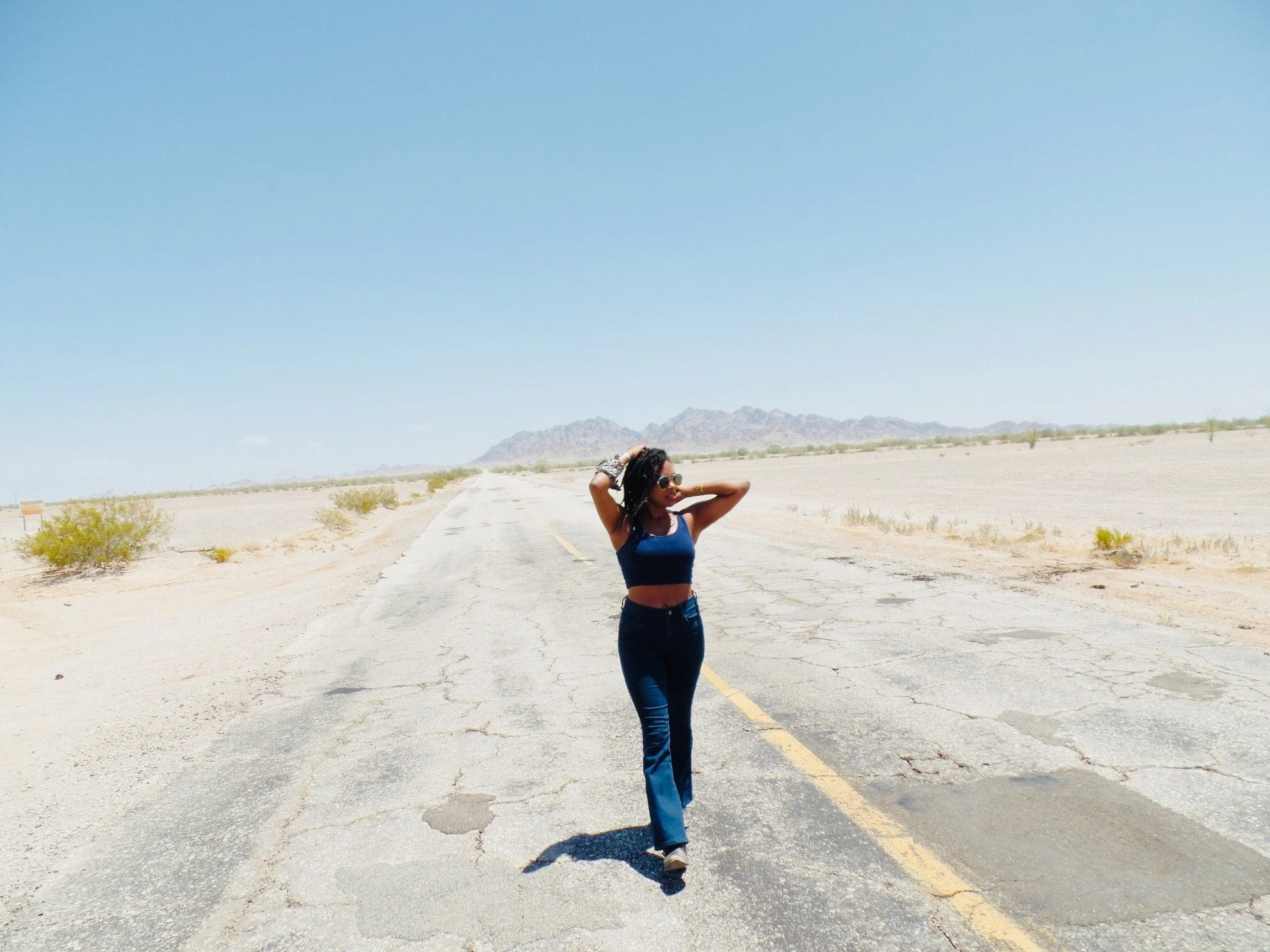 Author standing beside a remote desert highway near the Yuma borderlands in the Southwest desert.