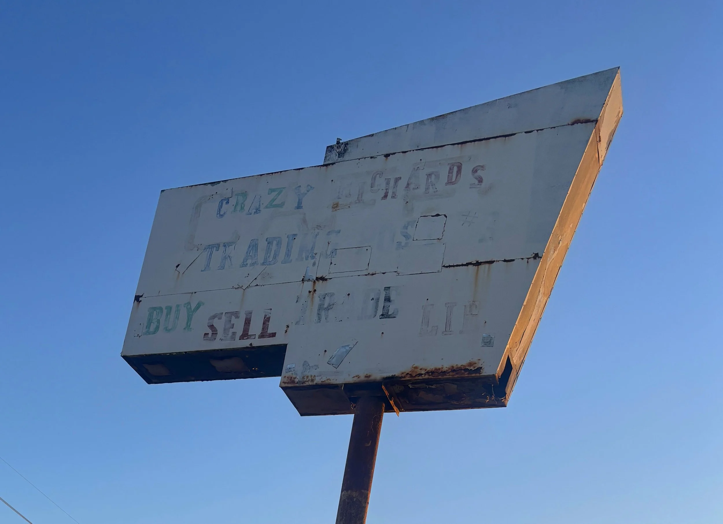 Weathered Crazy Richard’s Trading Post roadside sign along Highway 84 in Stanfield, Arizona.