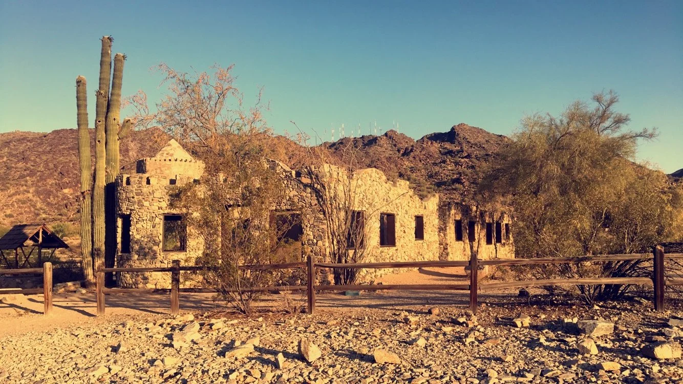 Tall multi-armed saguaro growing beside the historic stone ruins of Scorpion Gulch in Phoenix, Arizona, in 2016.