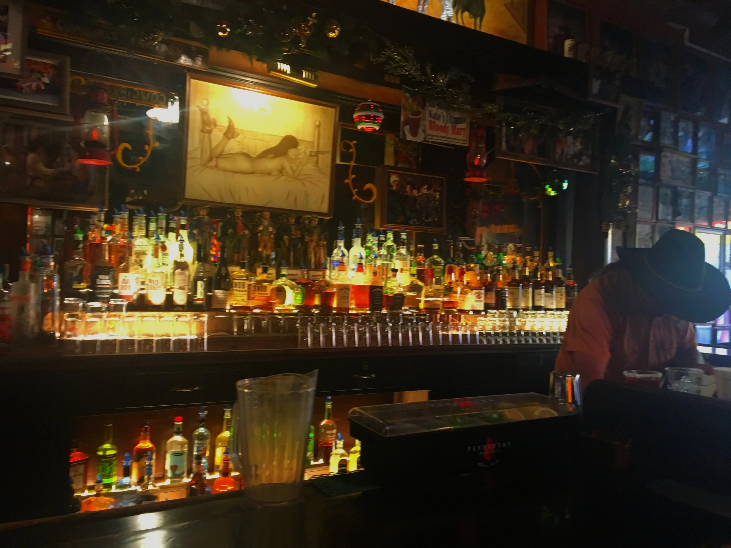A bartender standing behind the bar inside Big Nose Kate’s Saloon in Tombstone, Arizona.