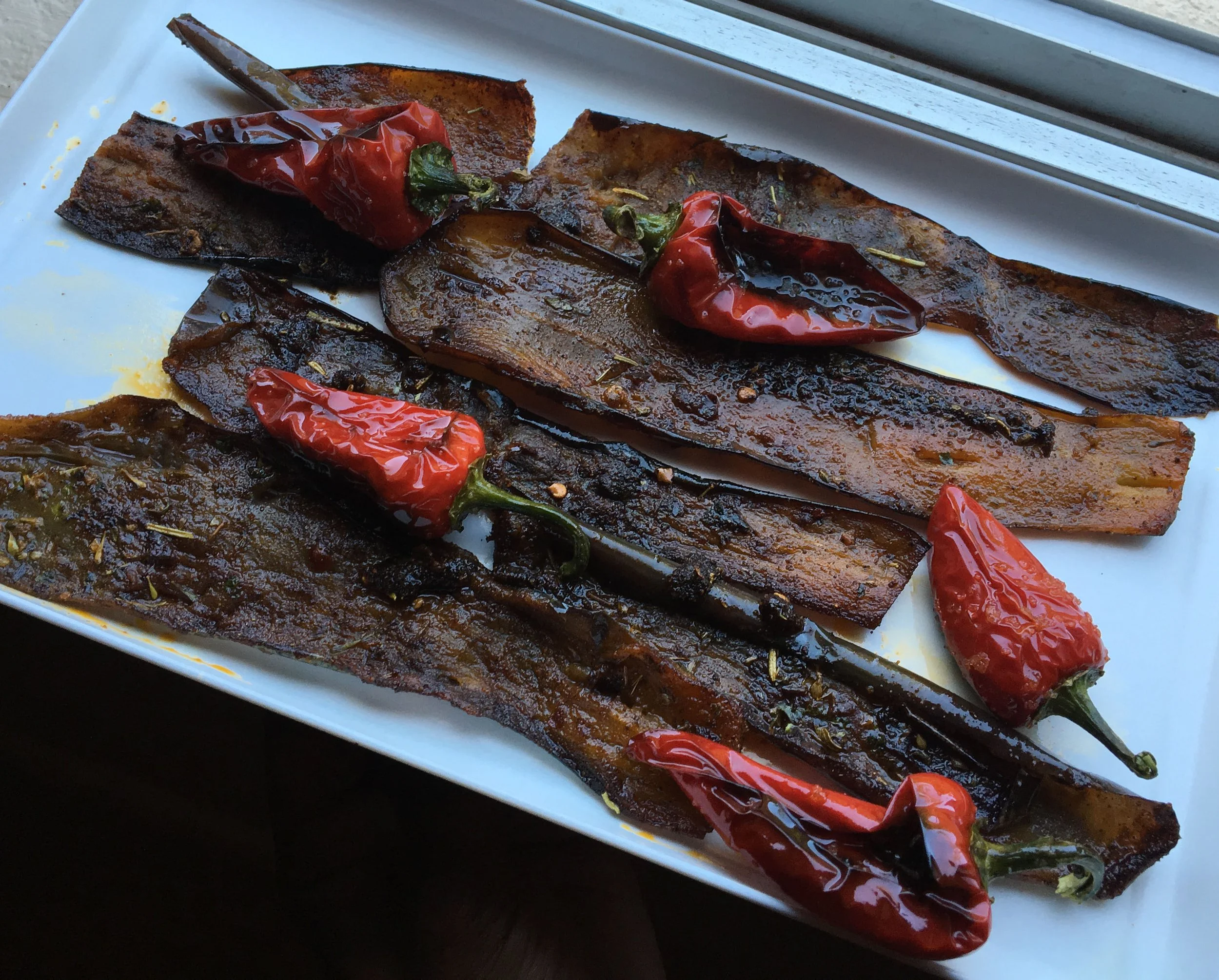 Fresno pepper wrapped in roasted eggplant skin as a plant-based alternative to bacon.