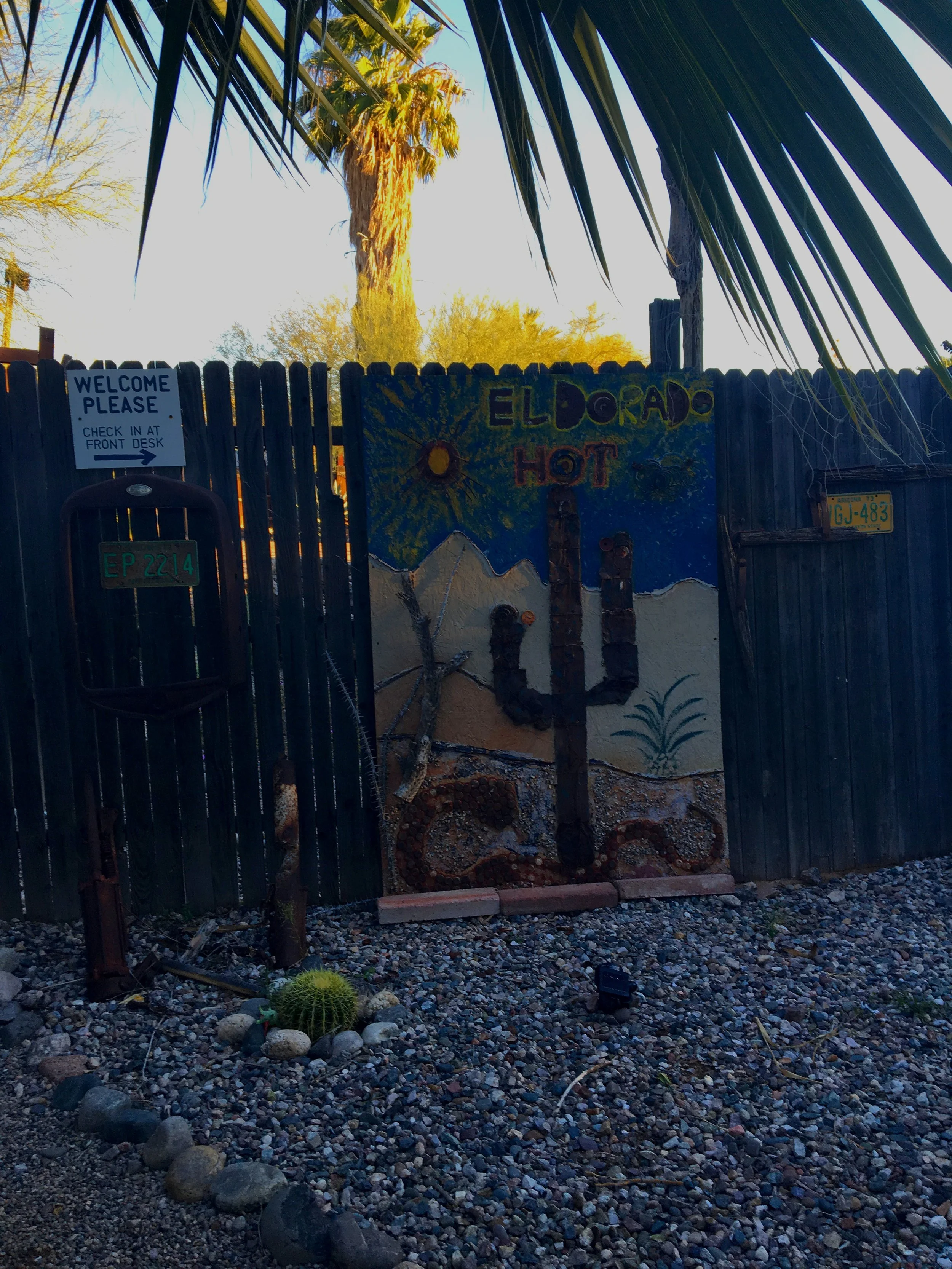Weathered wood fencing and a hand painted sign reflect the rustic, unpolished character of El Dorado Hot Springs.