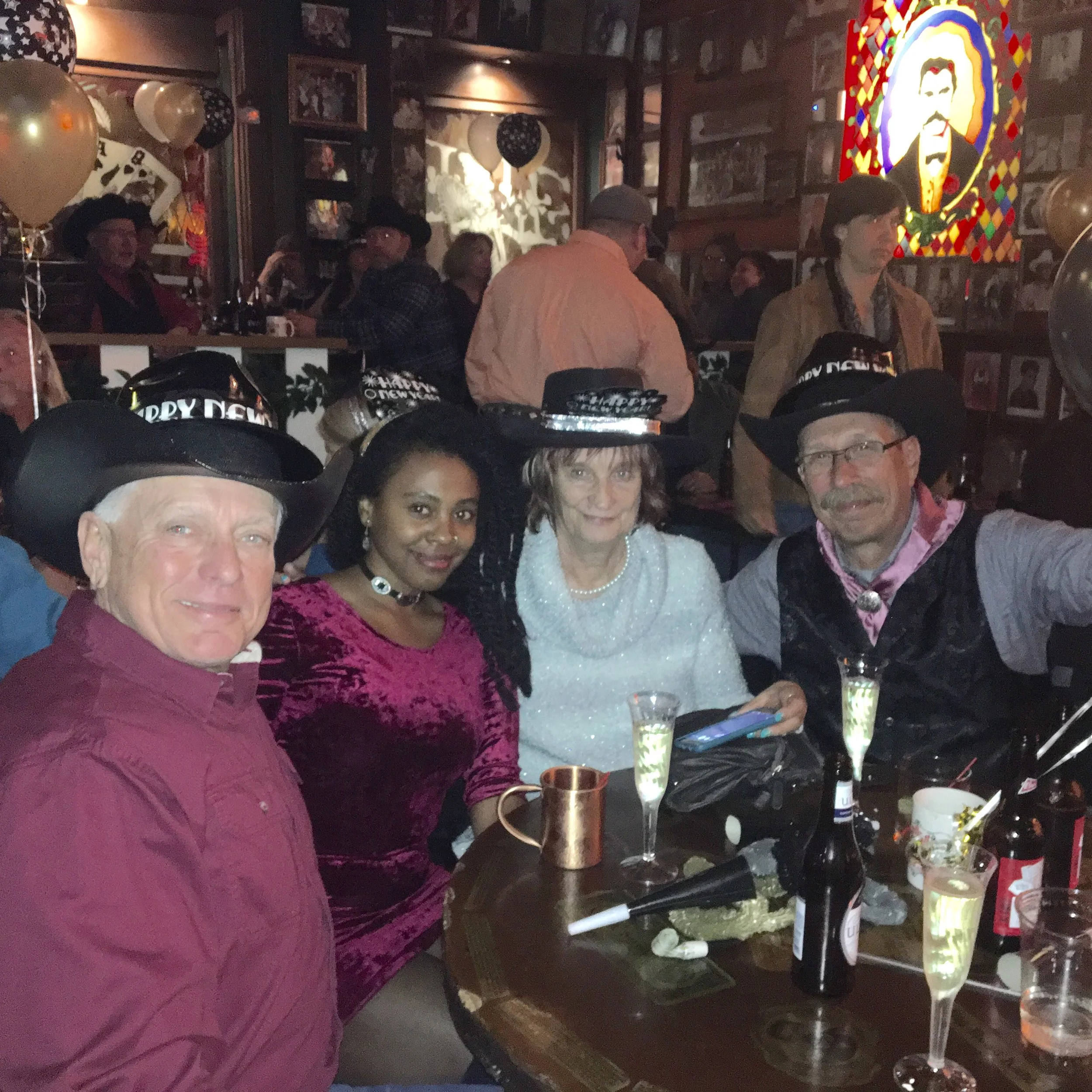 The author sitting with new friends inside Big Nose Kate’s Saloon during a New Year’s Eve celebration in Tombstone, Arizona.