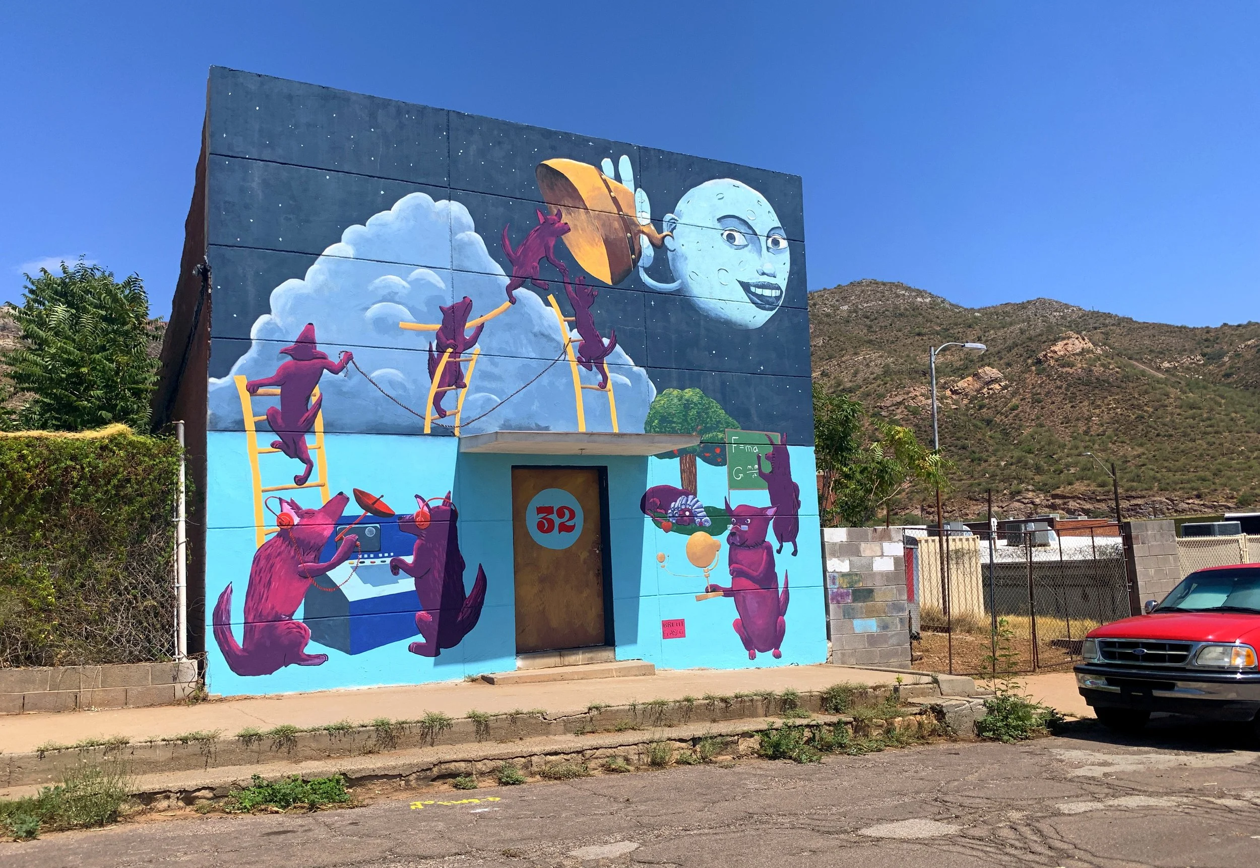 A building in downtown Superior, Arizona with a moon mural.