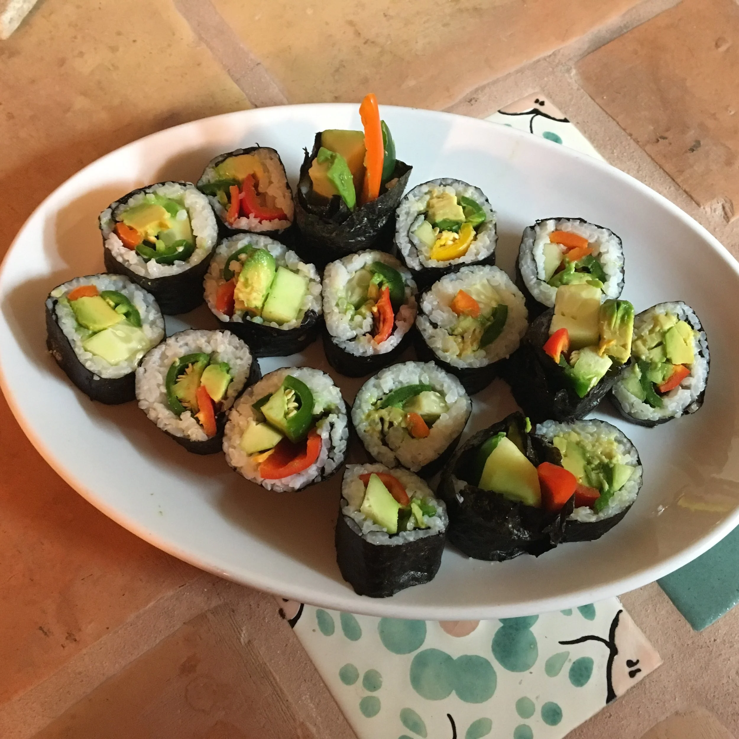 Vegan sushi rolls filled with jalapeños, sweet peppers, avocado, and cucumber.