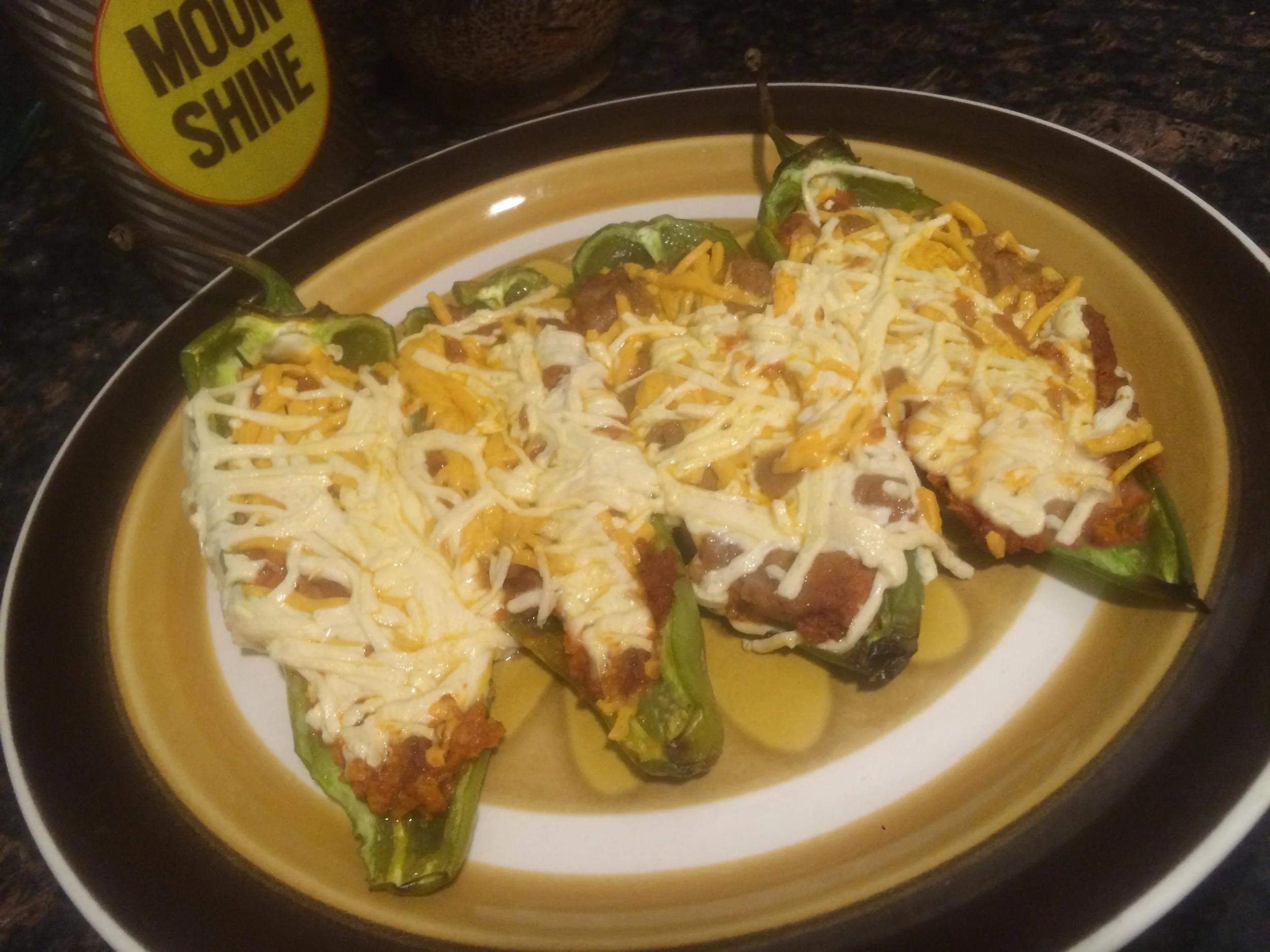 Roasted Hatch chile pepper topped with melted vegan cheese and served as a Southwest-inspired appetizer.