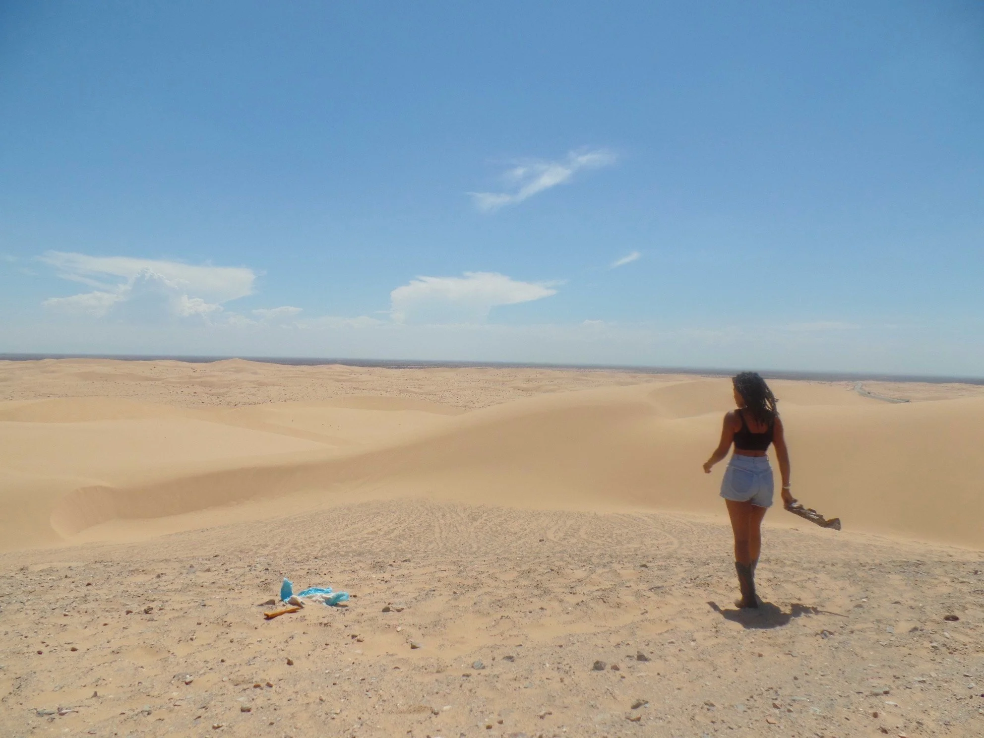 Traveler exploring the vast sand dunes in Southern California.