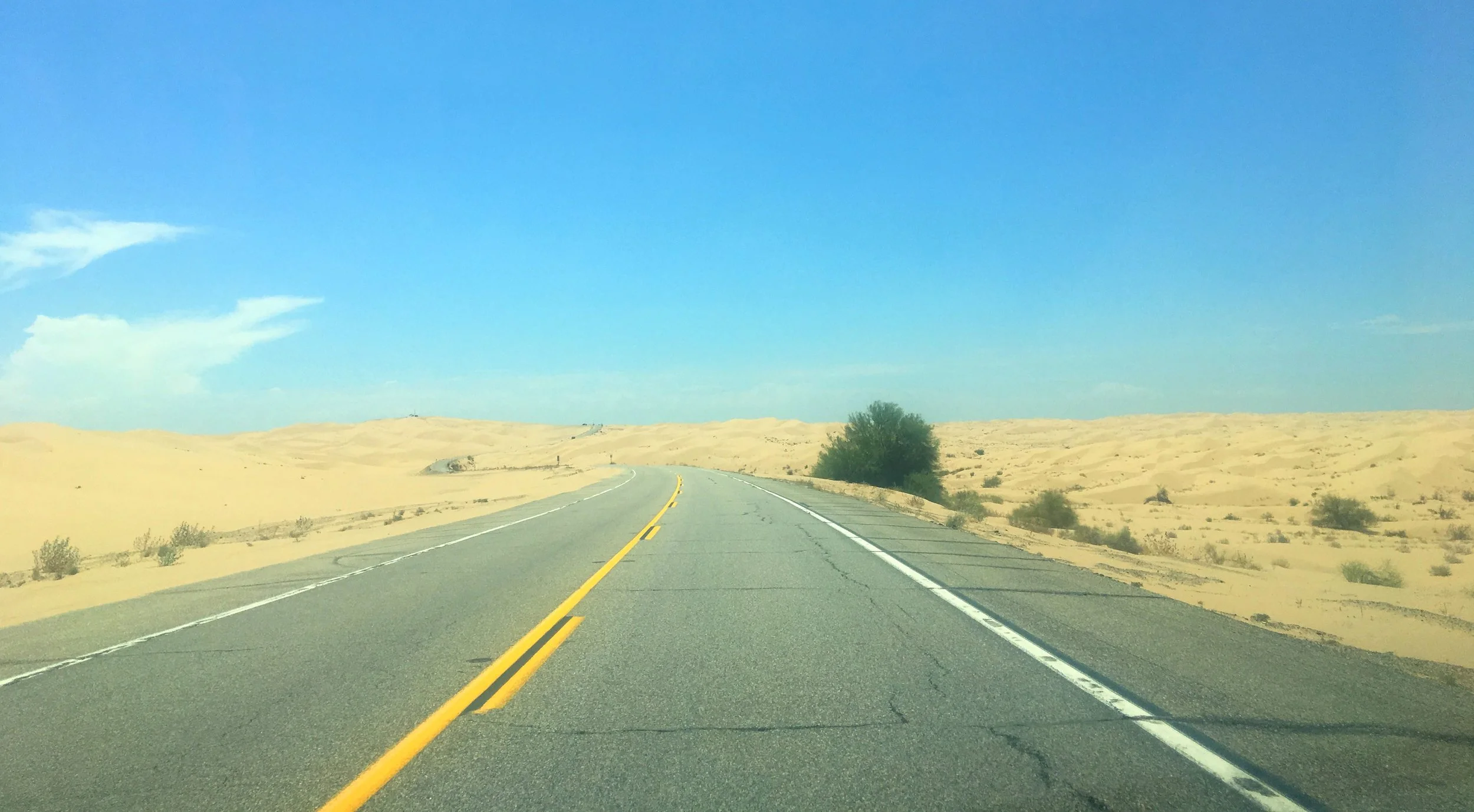 Desert road leading into the Imperial Sand Dunes in Southern California.