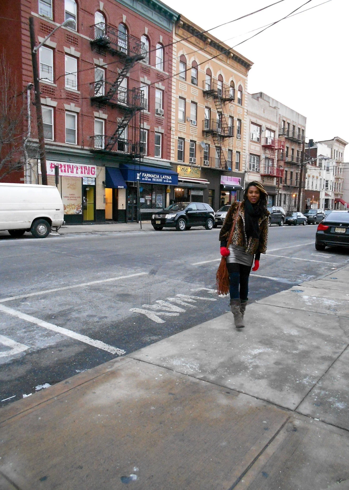 Walking along a neighborhood street in New Jersey with historic brick buildings and fire escapes before visiting New York City.