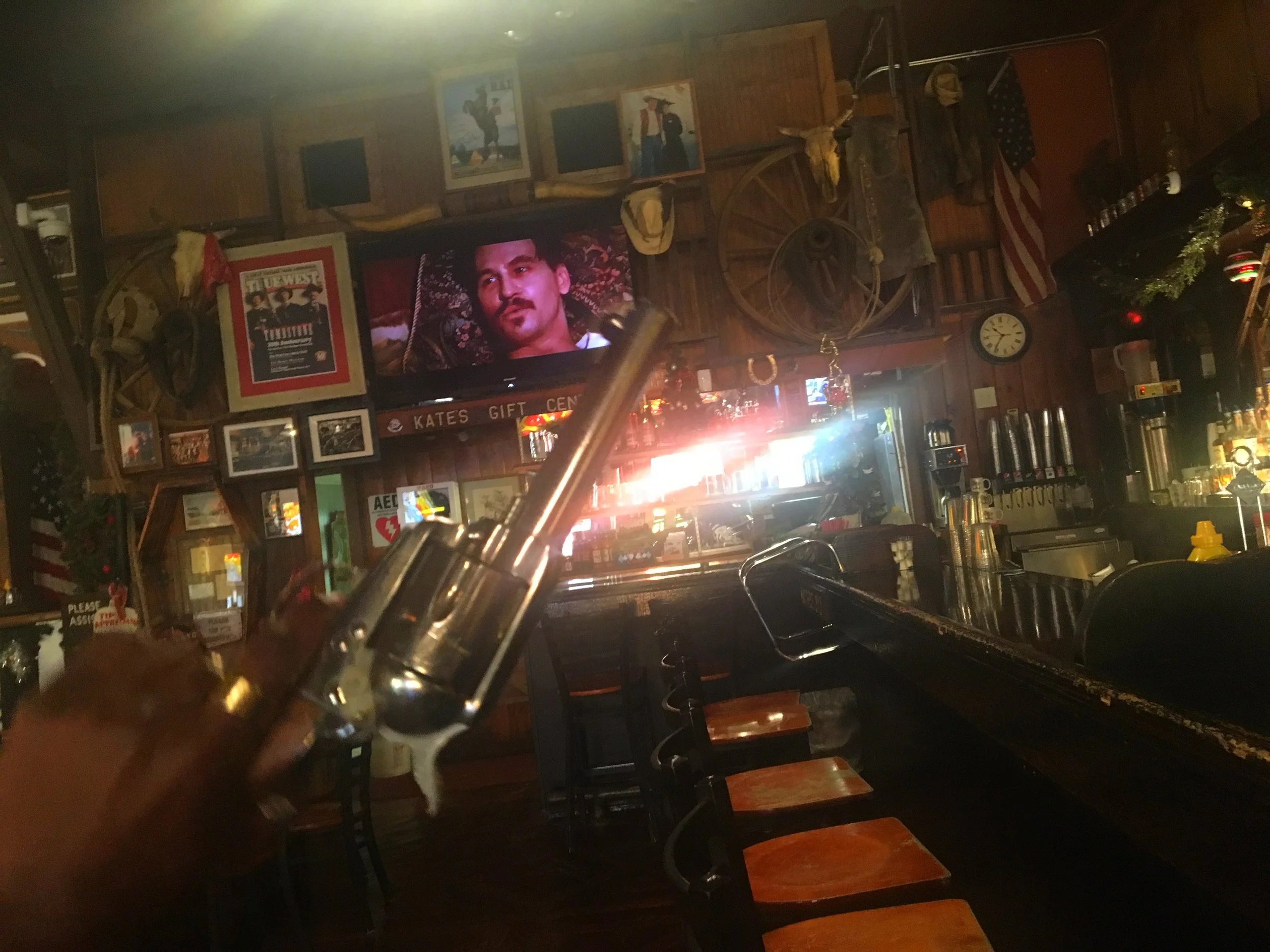 The movie Tombstone playing on loop on screens inside Big Nose Kate’s Saloon during a New Year’s Eve celebration