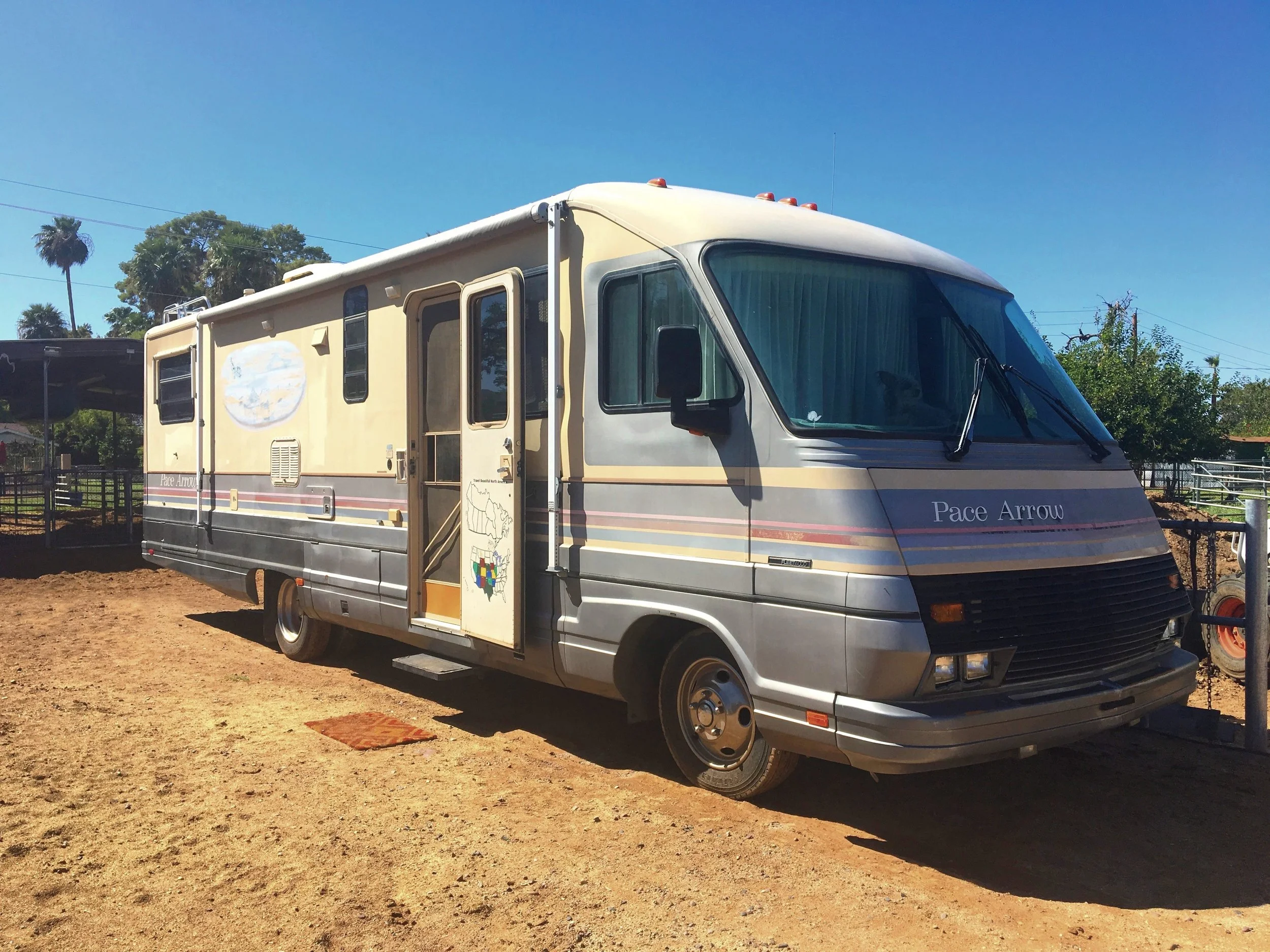 1990 Fleetwood Pace Arrow motorhome, known as the Desert Prowler, parked in the desert ranch landscape.