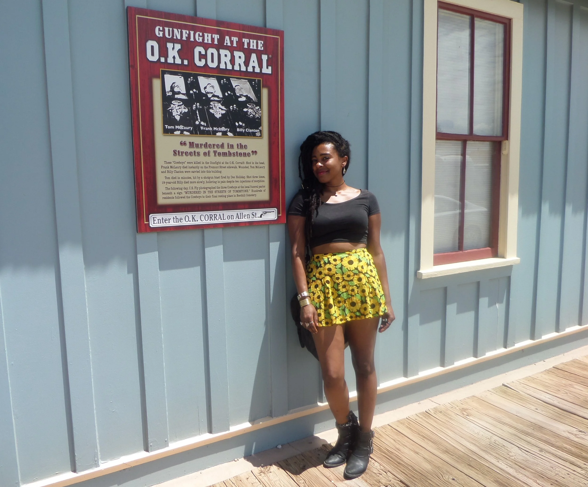 Visitor standing in front of the OK Corral sign in Tombstone, Arizona