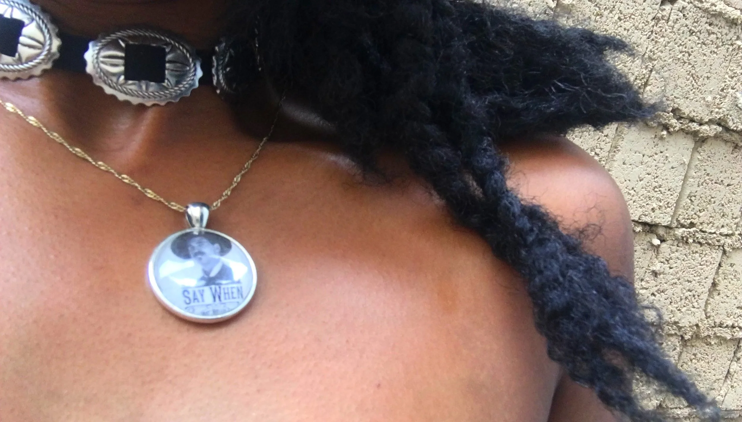 Close-up of the author wearing a ‘Say When’ necklace in Tombstone, Arizona