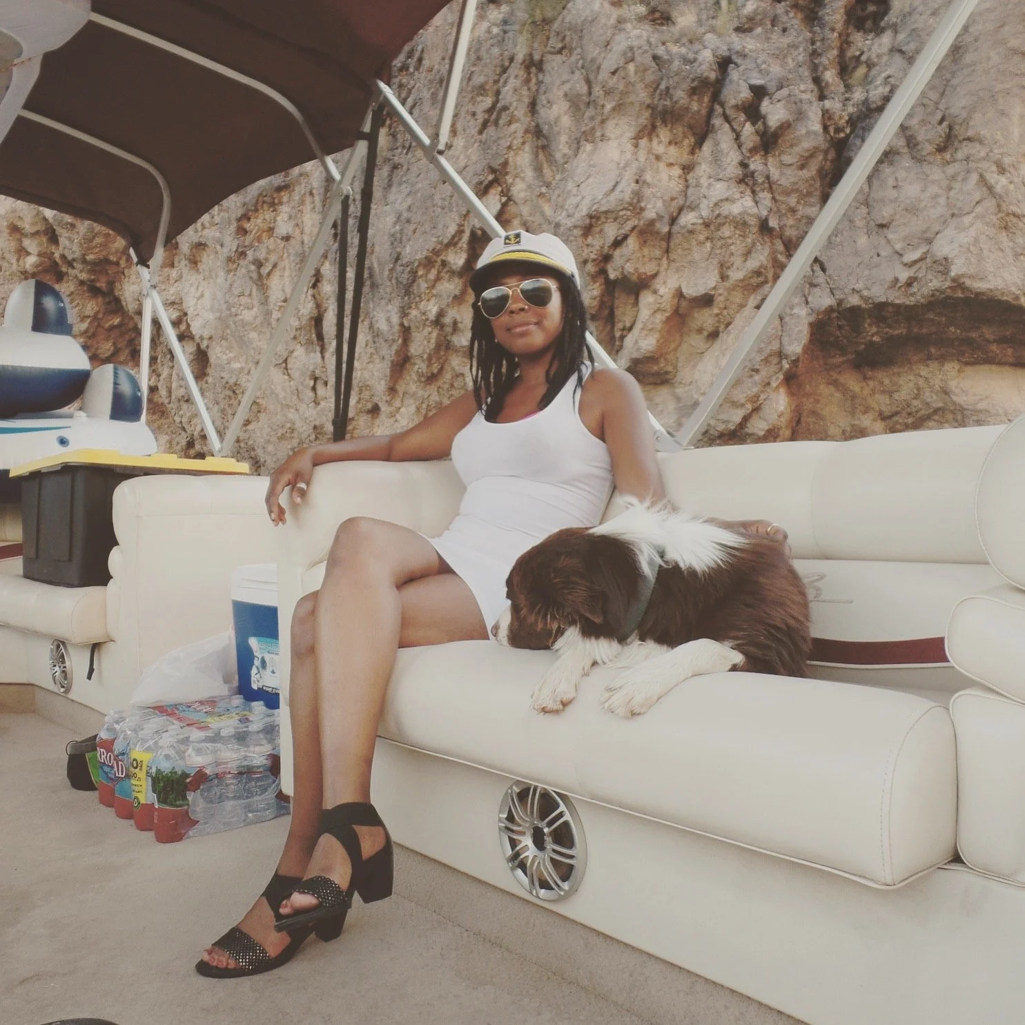 Relaxing on a pontoon boat with a dog while floating through the canyon waters of Saguaro Lake, Arizona.