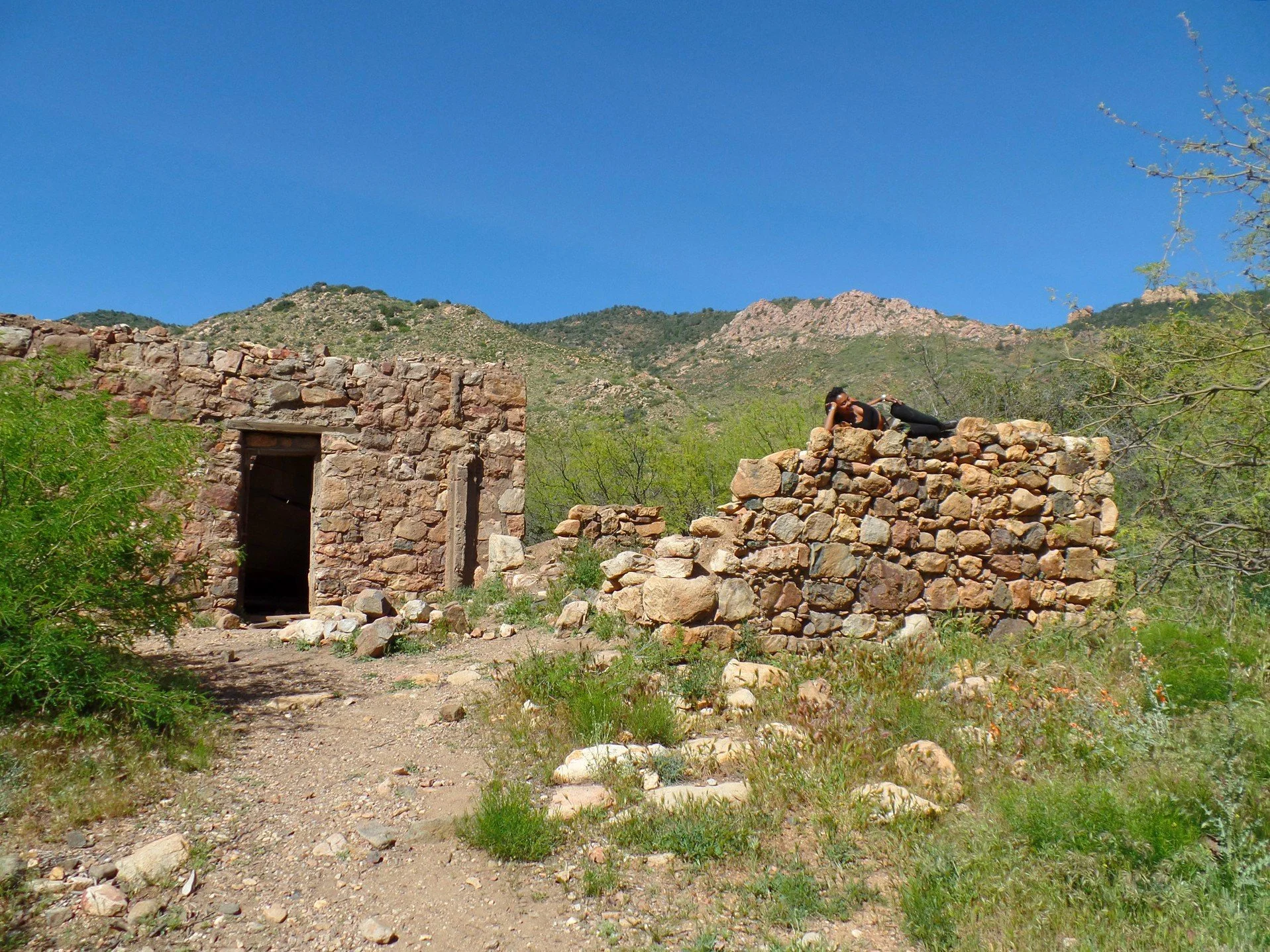 Crumbling foundation remains from an abandoned site in Arizona mountains.