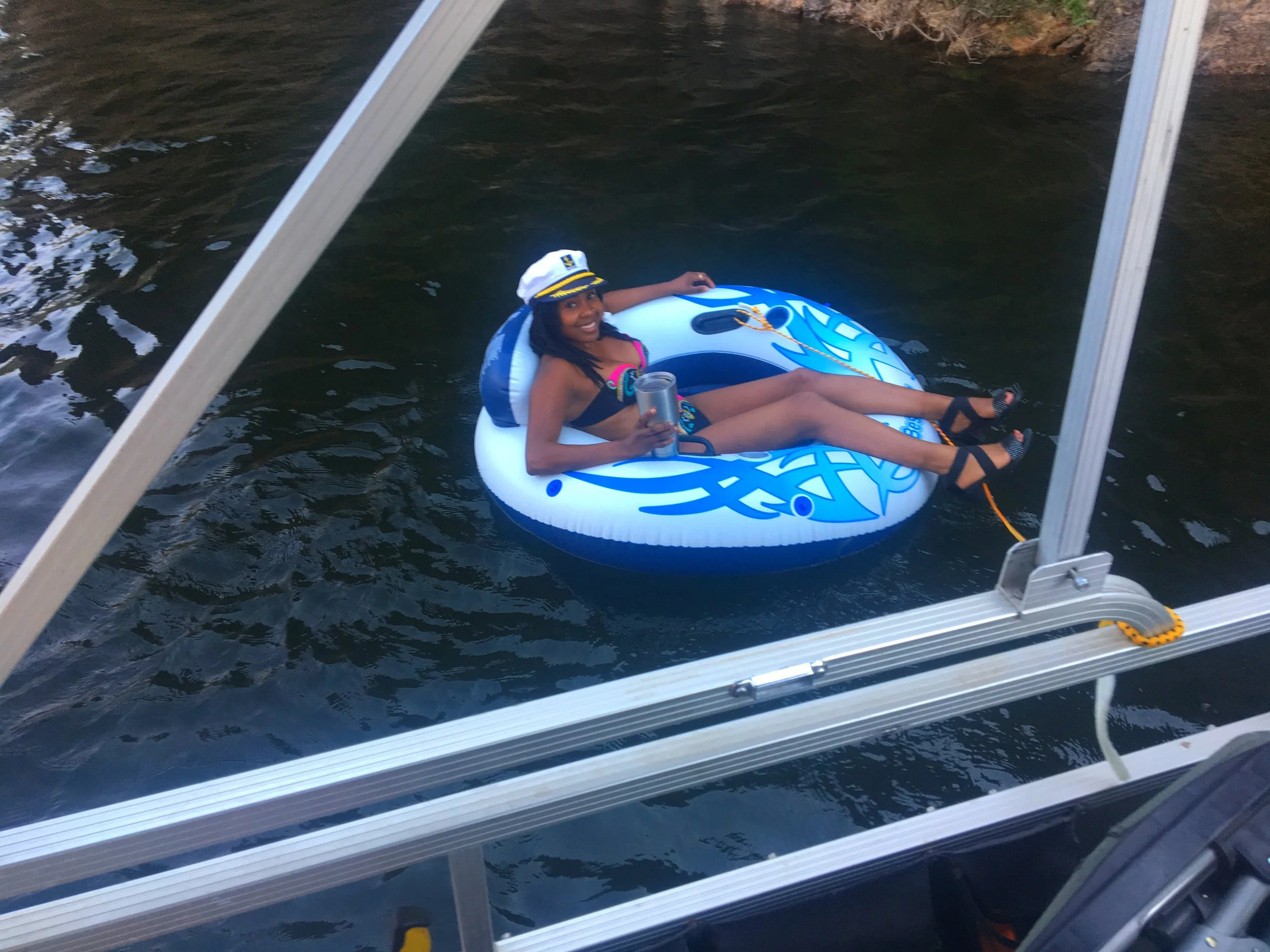 Floating on a tube in the calm waters of Saguaro Lake surrounded by rugged desert canyon scenery in Arizona.
