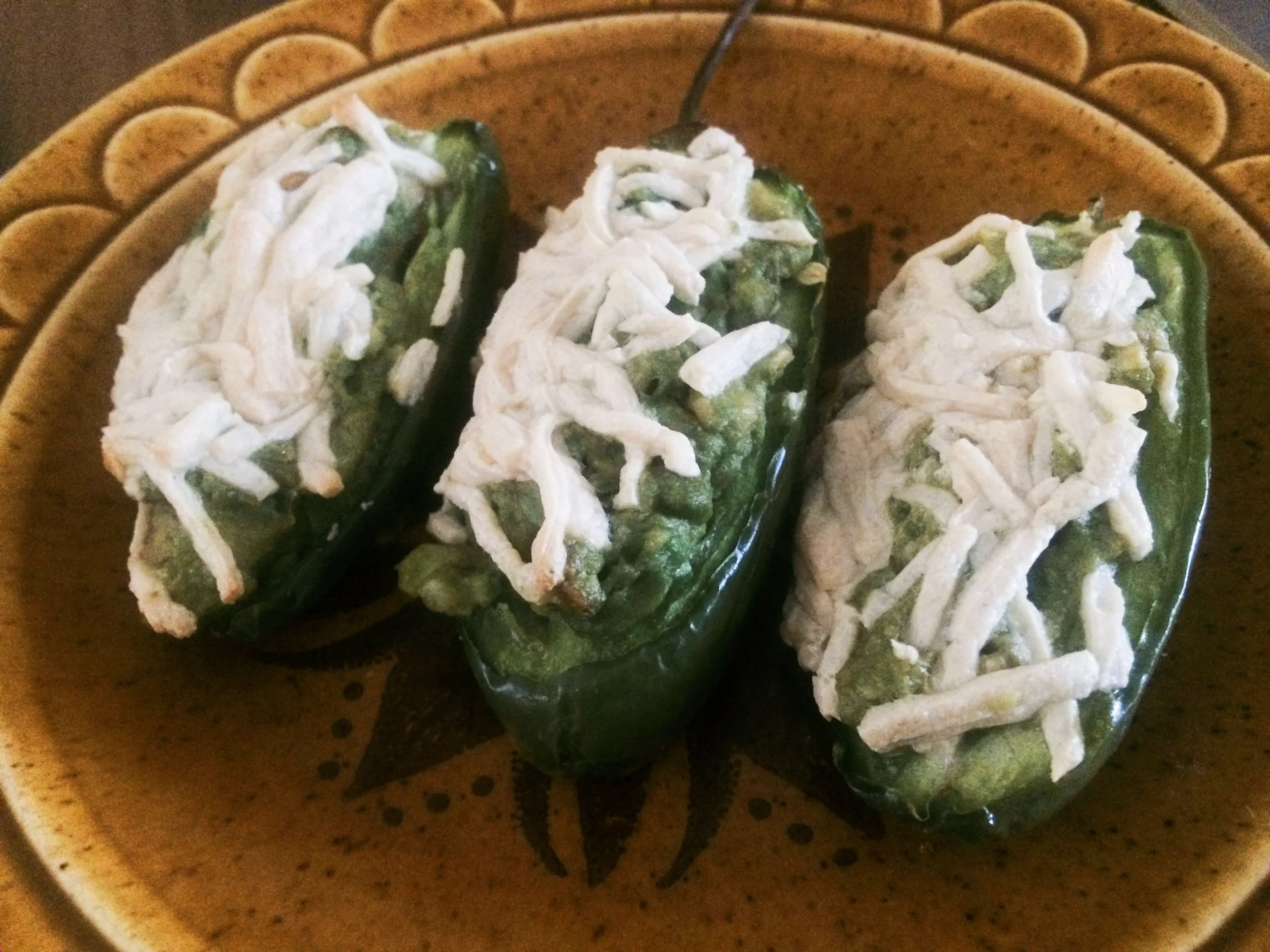 Jalapeño peppers topped with melted vegan cheese and baked until golden.