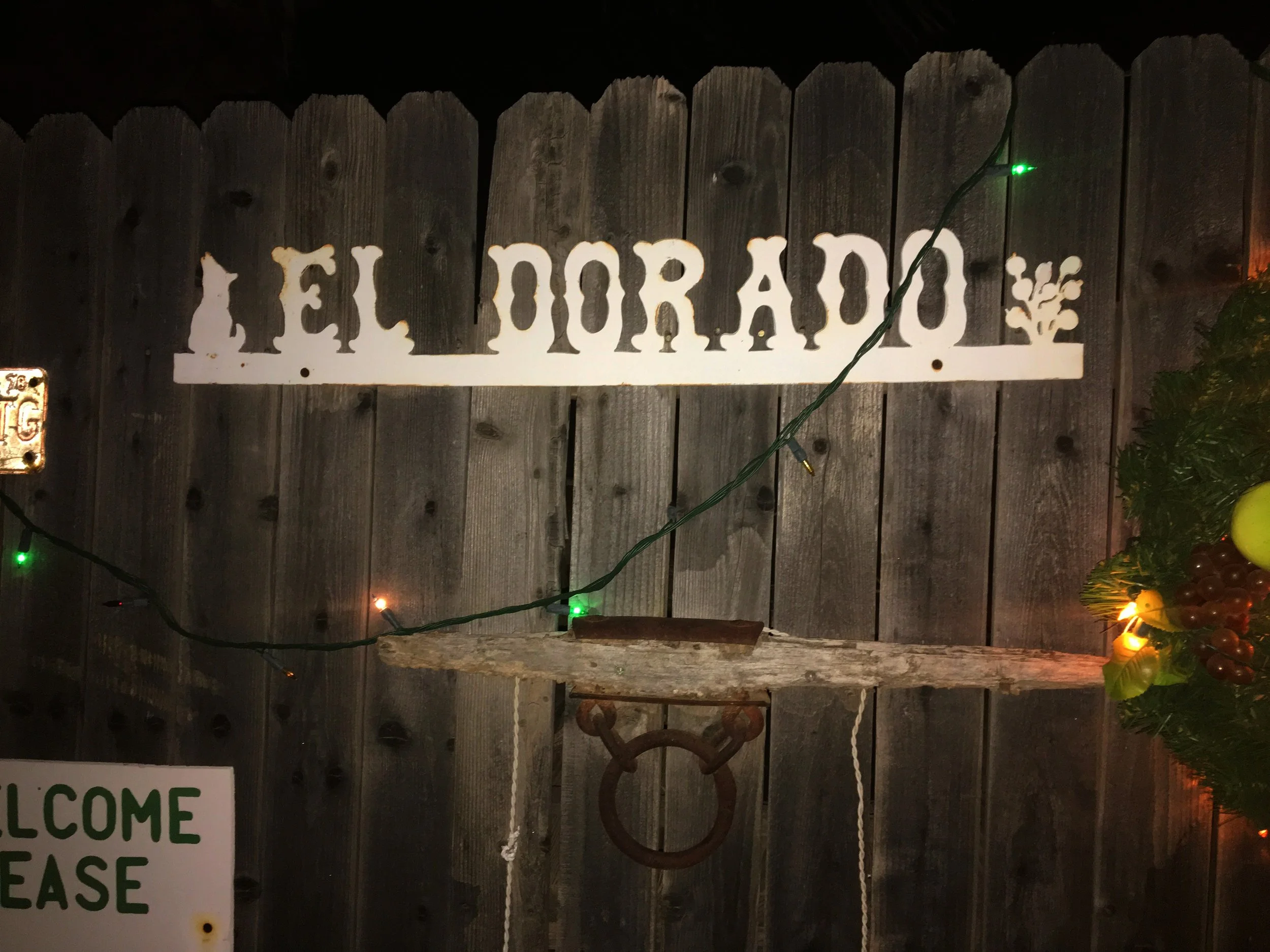 Evening lighting and rustic sign at El Dorado Hot Springs after sunset.