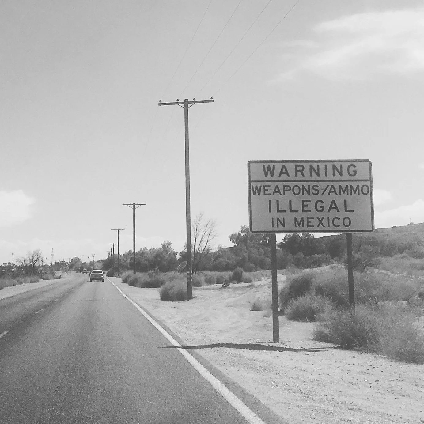 Warning sign along a remote desert highway near Yuma, Arizona close to the Mexico border.