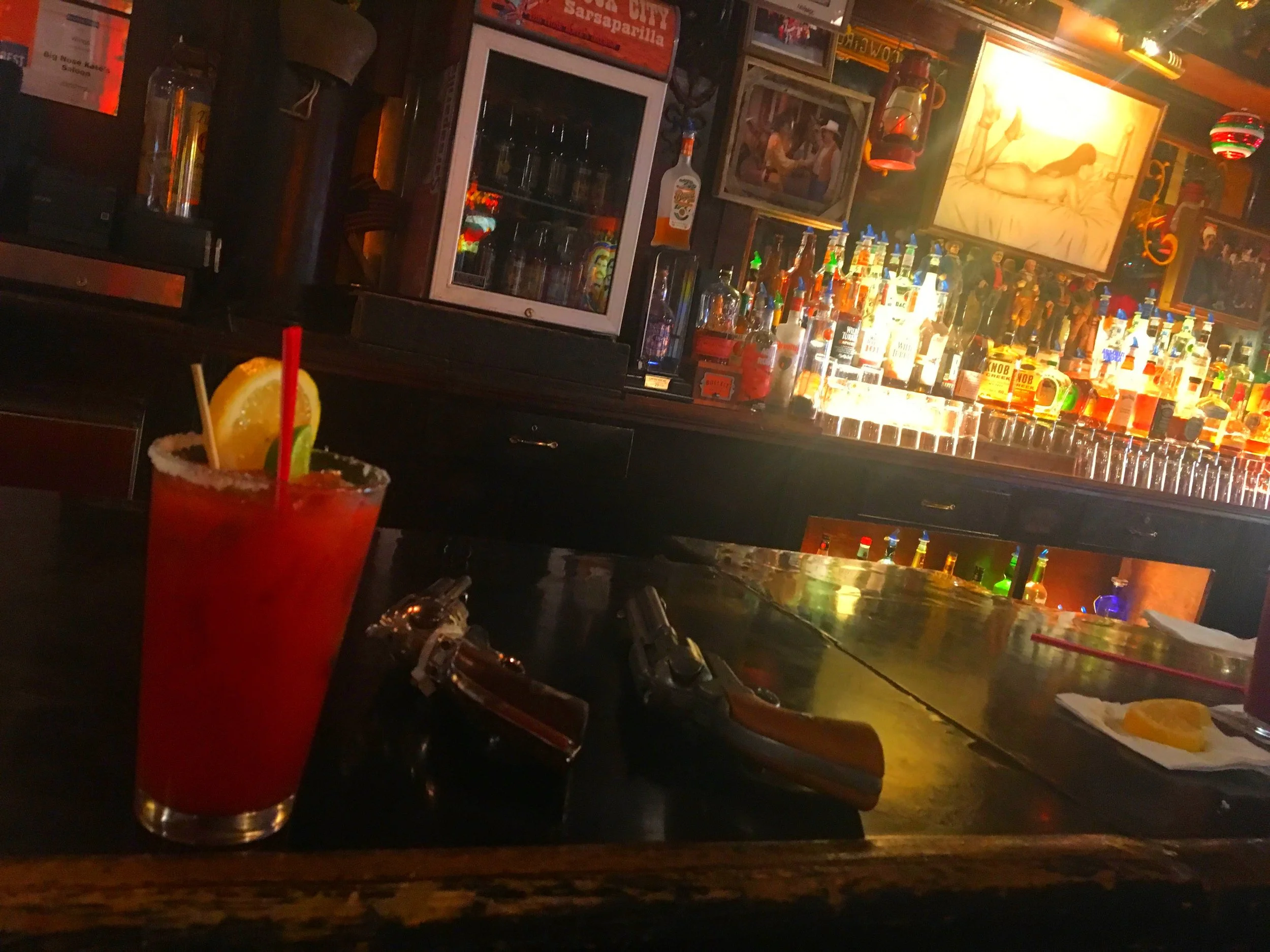 A Bloody Mary drink on the bar alongside replica pistols inside Big Nose Kate’s Saloon in Tombstone, Arizona