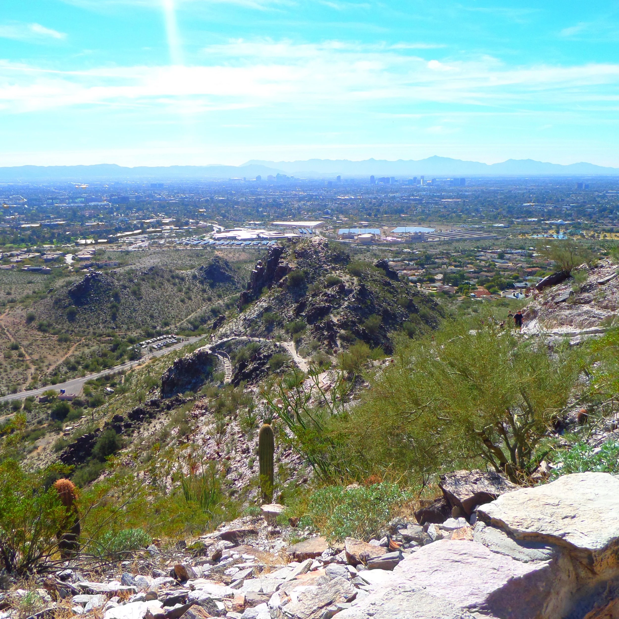 View from Piestewa Peak overlooking the Phoenix metropolitan area and the rocky summit ridge below.