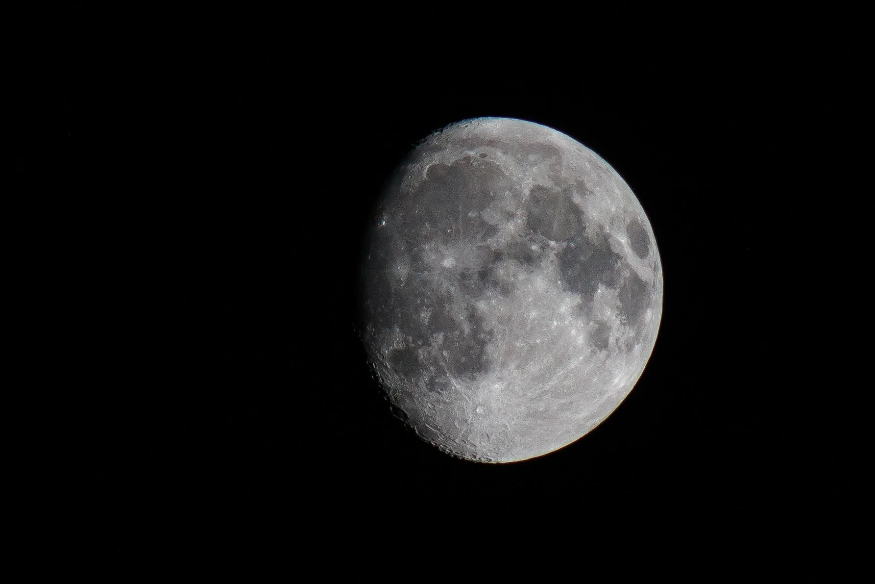 Close-up of the moon showing craters and surface details against a black night sky.