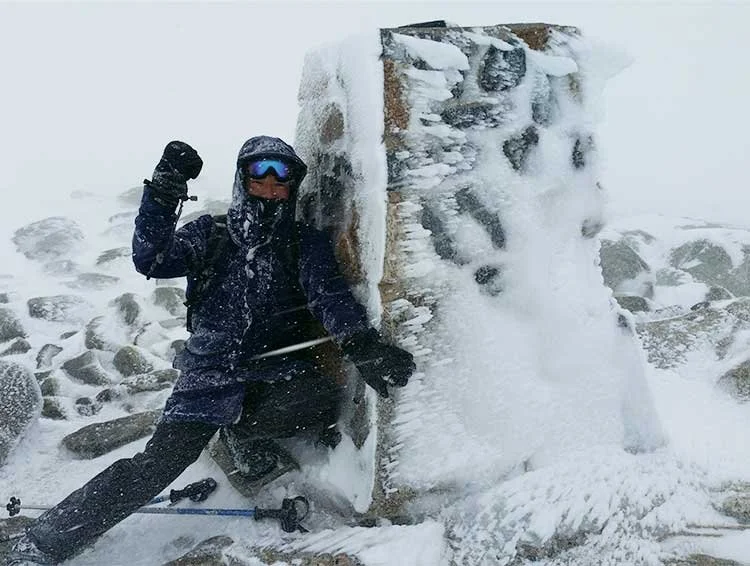 At the Mt Kosciuszko summit marker in winter