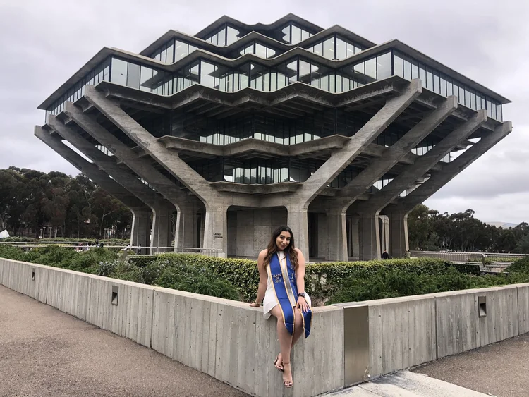 Avita in front of a striking modern building