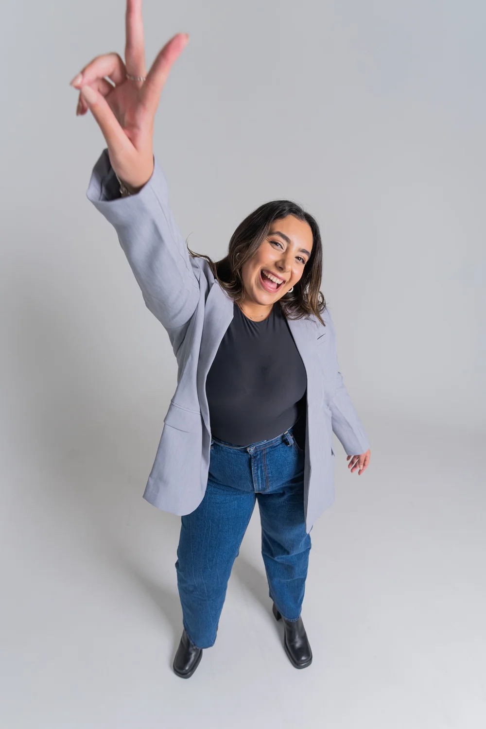 Avita throwing a peace sign and laughing