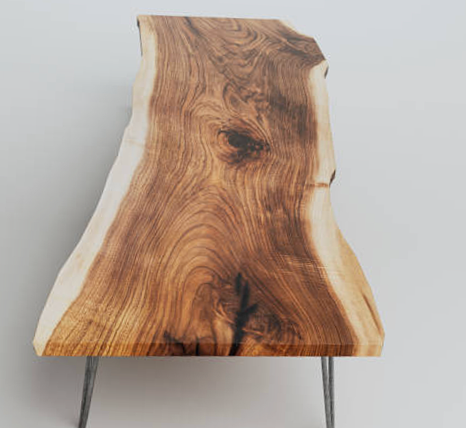 A wooden table with a natural irregular shape and metal legs.