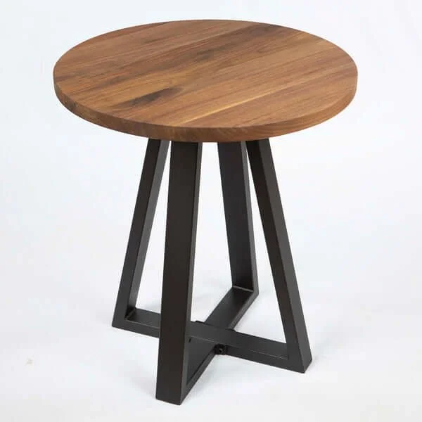 A small round side table with a wooden top and black metal legs.