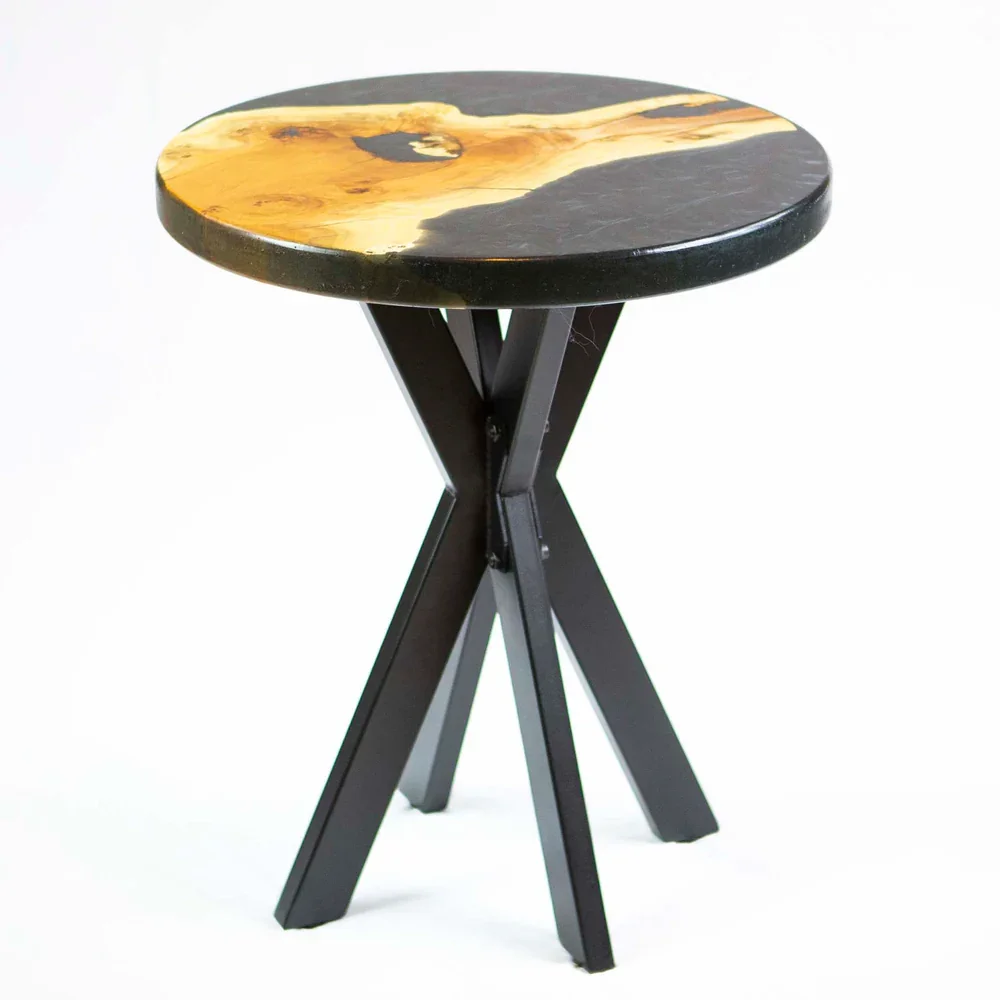 A small round table with a black and yellow marble top and black wooden legs.