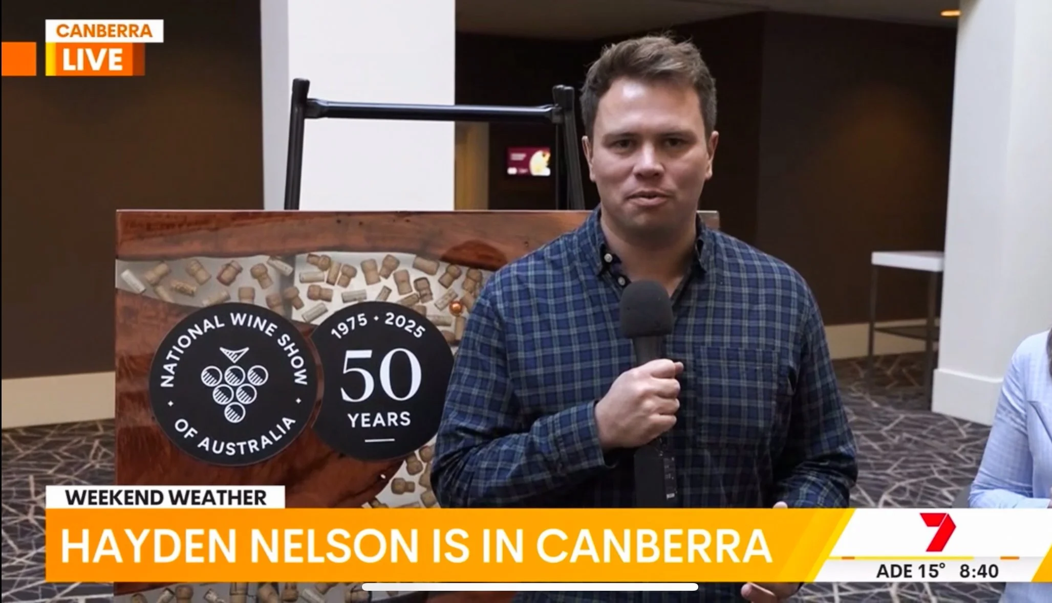 Burl & Griffin custom timber board featured on 7 News Canberra with presenter Hayden Nelson at the Australian National Wine Show.