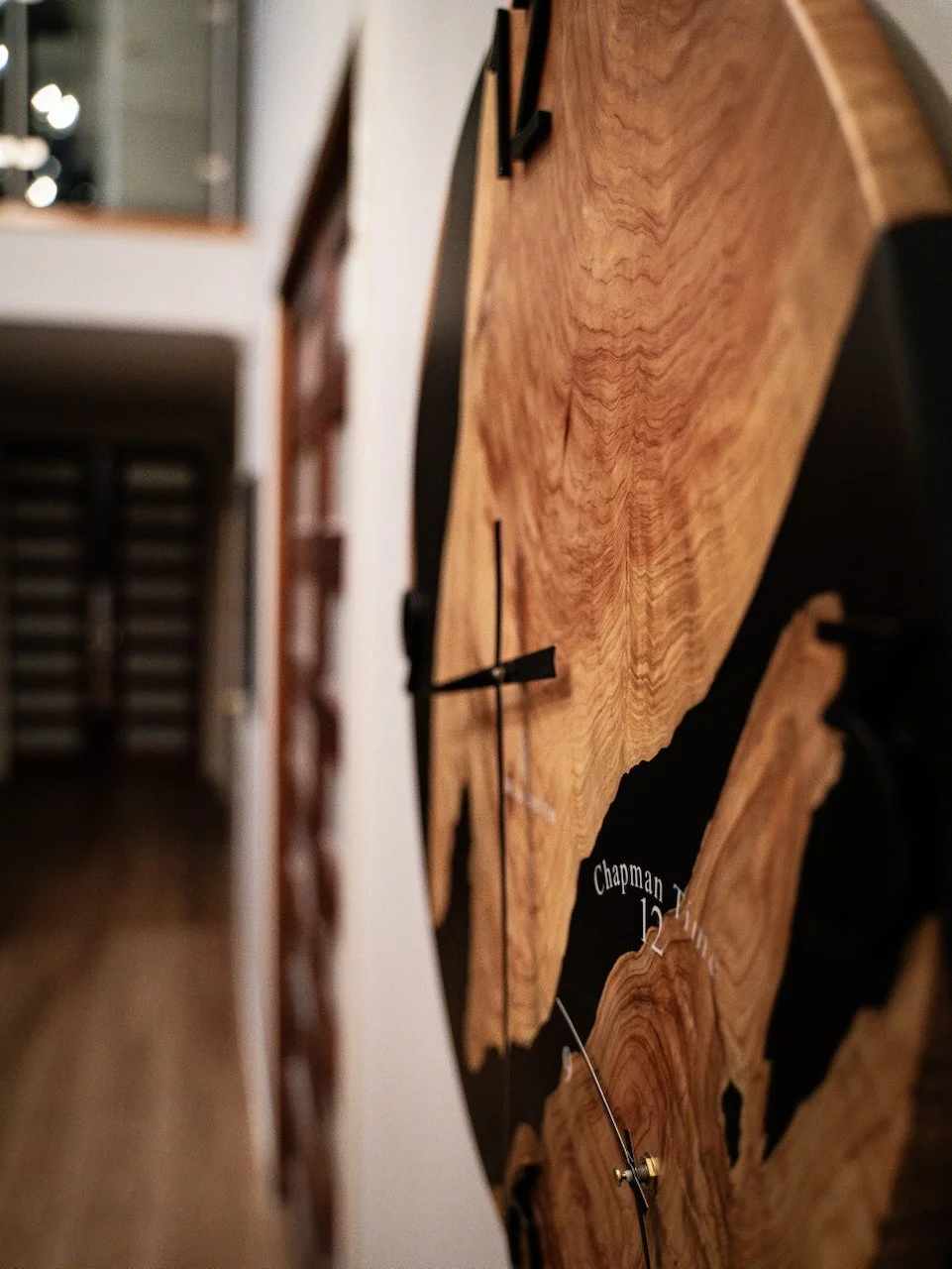 Side view of the 60cm Dual Clock showing the durable hard coat finish and timber depth.