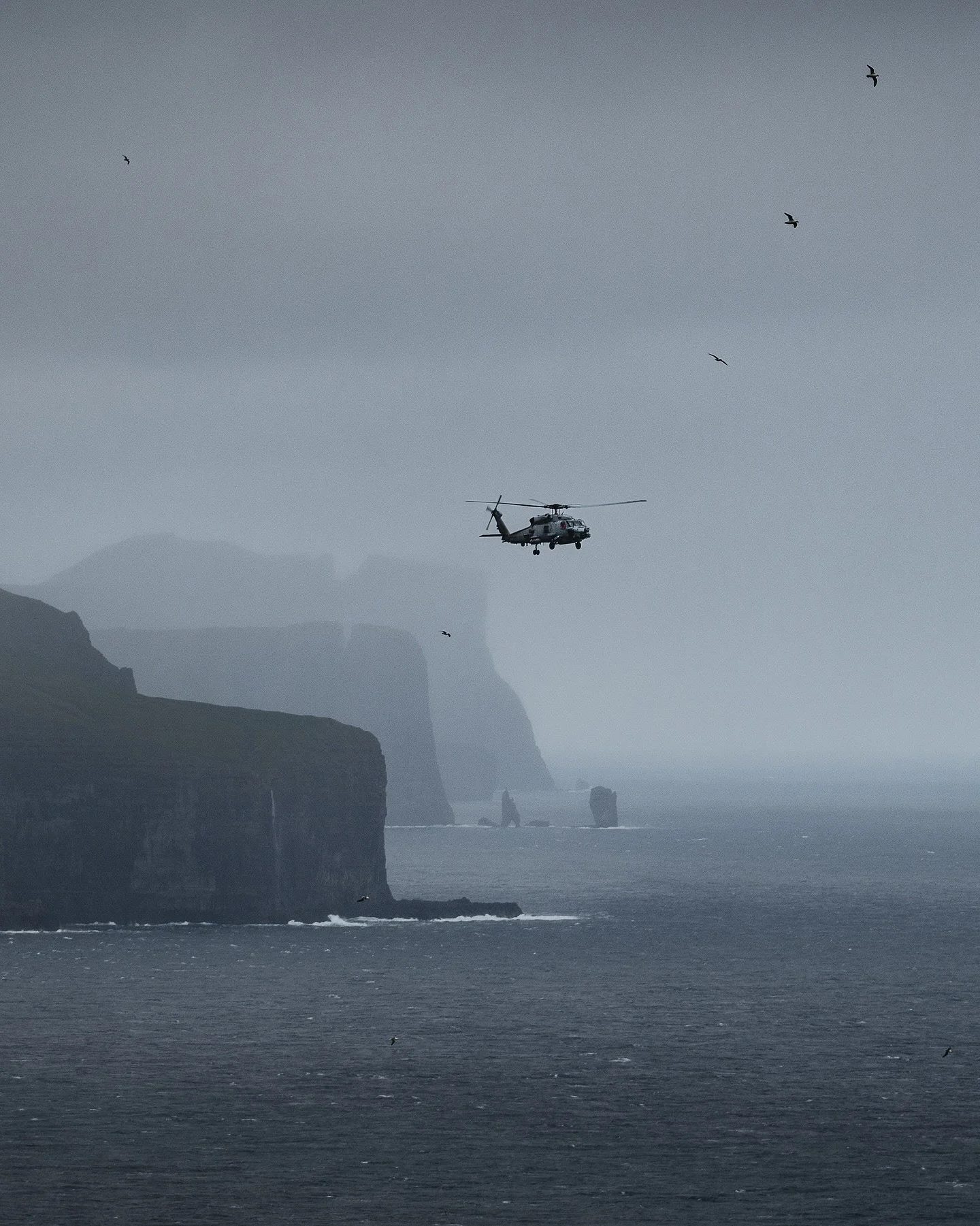 Not something you see every day 👀
 I captured a danish military helicopter on sightseeing here in the Faroe Islands at Kallurin lighthouse 🚁🇫🇴

Even they can&rsquo;t resist flying over these dramatic cliffs and raw landscapes. Because honestly&he
