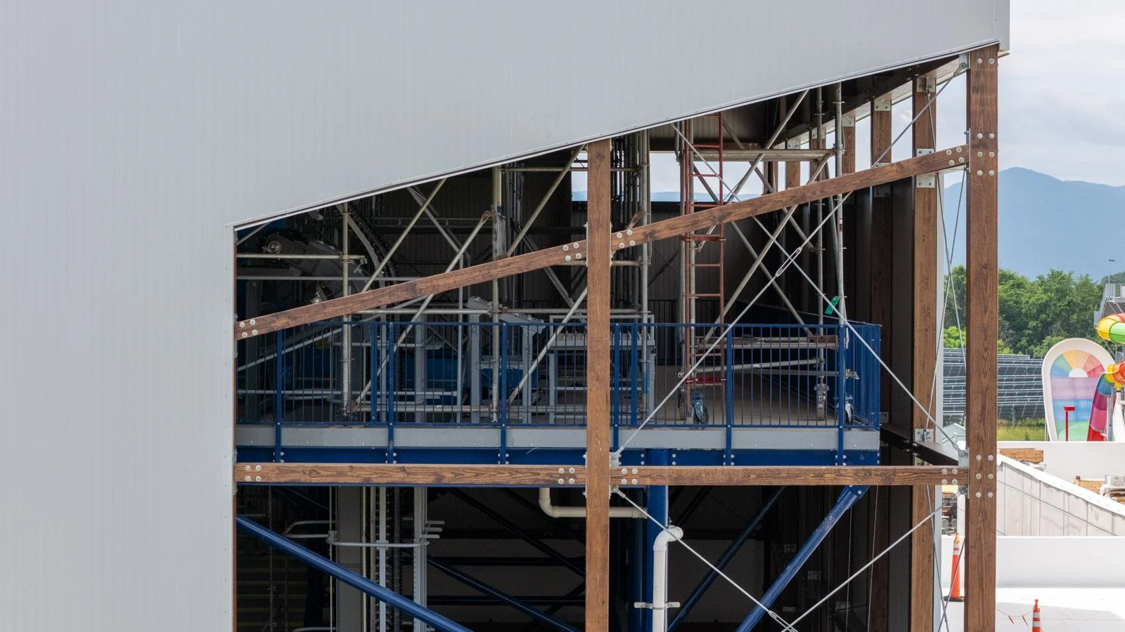 Insulated metal panel stair tower under construction at Massanutten Water Park with waterslide tubes and site equipment in Harrisonburg, VA
