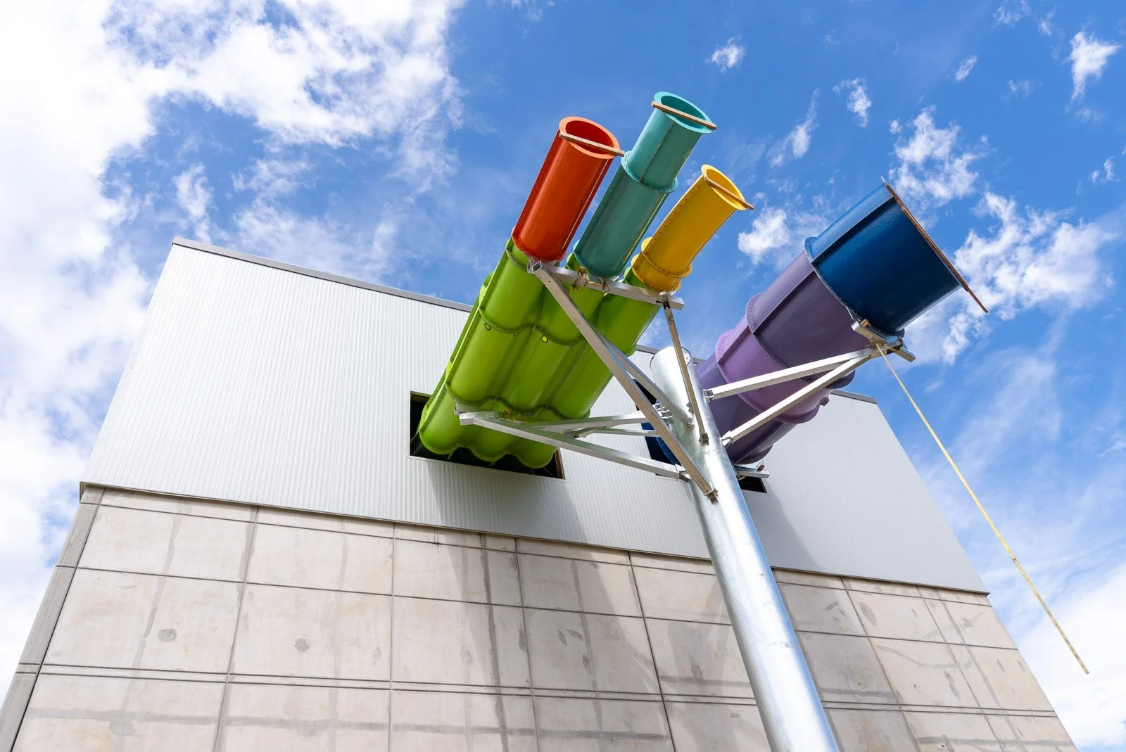 Close-up of insulated metal wall panels where colorful waterslide tubes exit the Massanutten Water Park stair tower