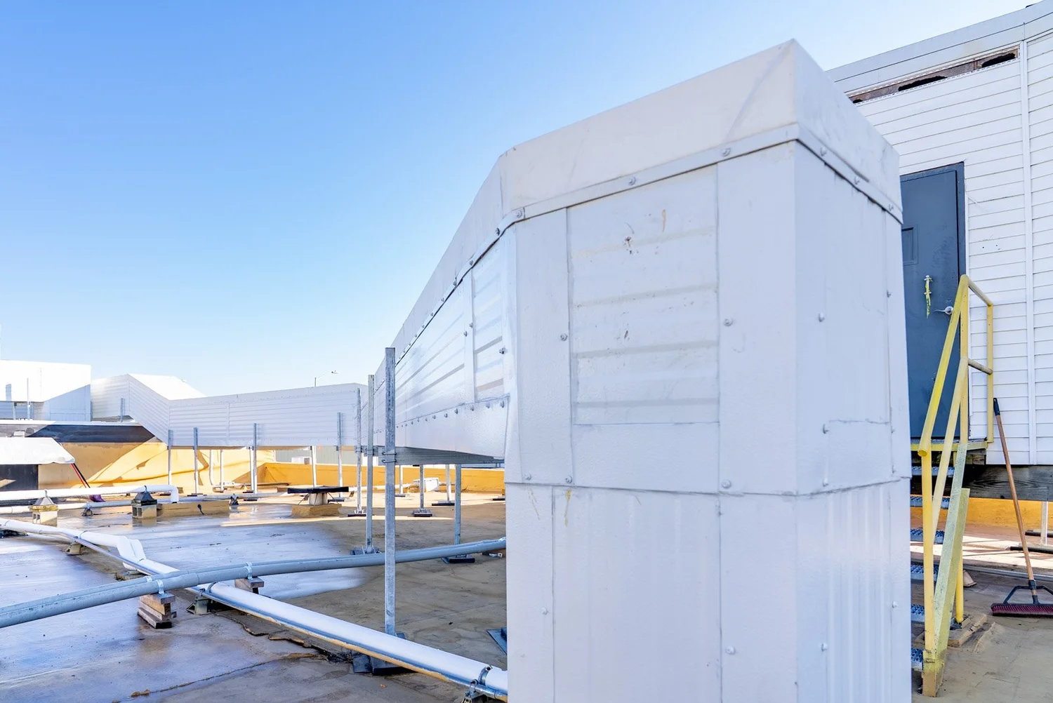 Custom-fabricated insulated metal panel duct housing on a rooftop