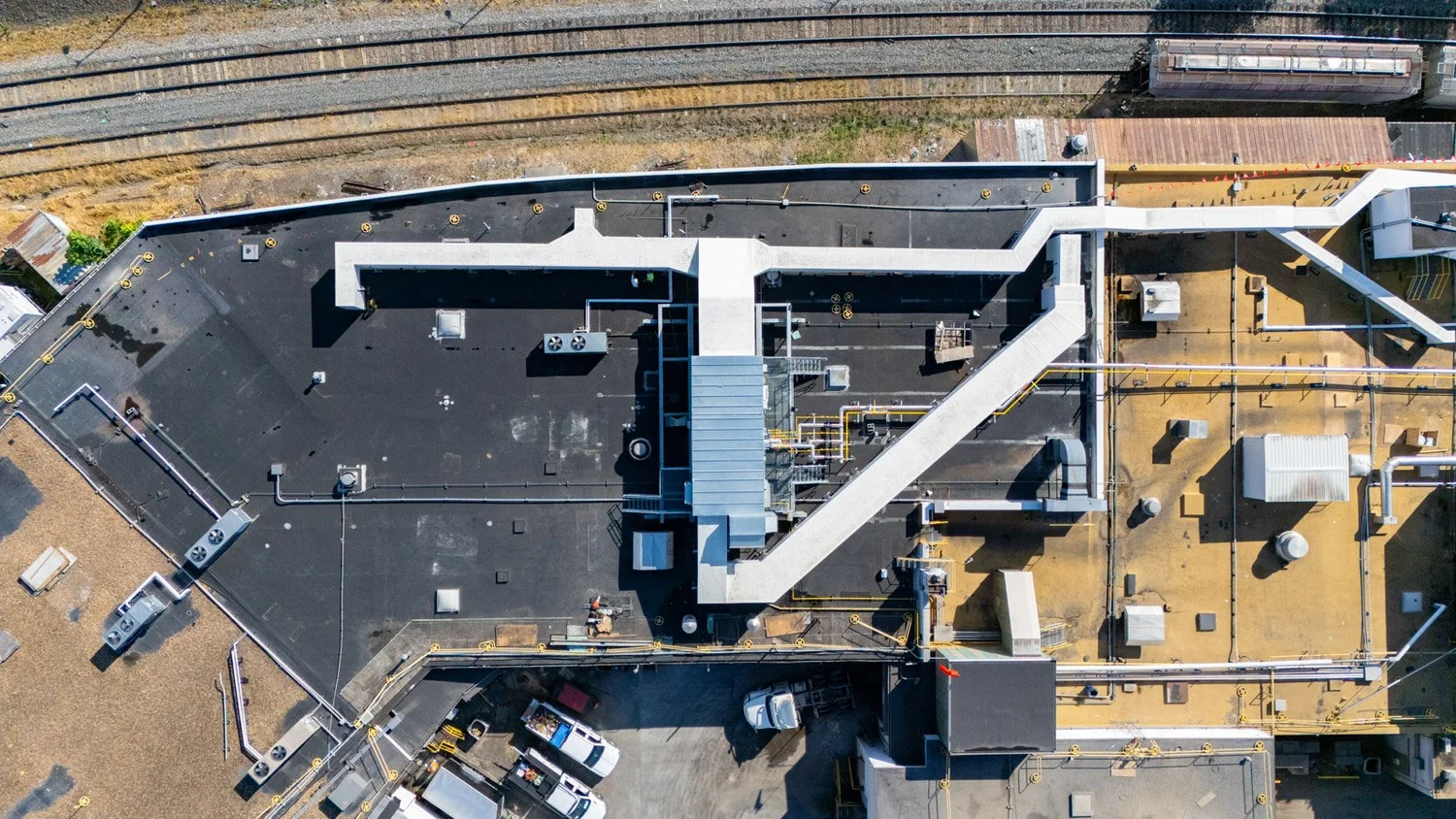 Aerial view of a rooftop insulated metal panel duct system on an industrial building