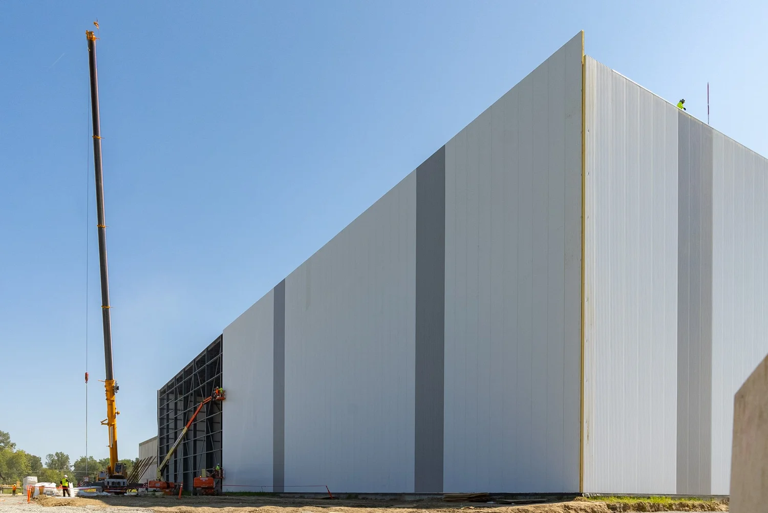 Corner of the FreezePak building with tall white insulated metal panel walls