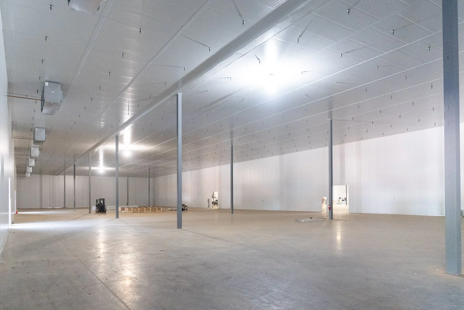 Large, bright interior of a finished insulated cold storage building