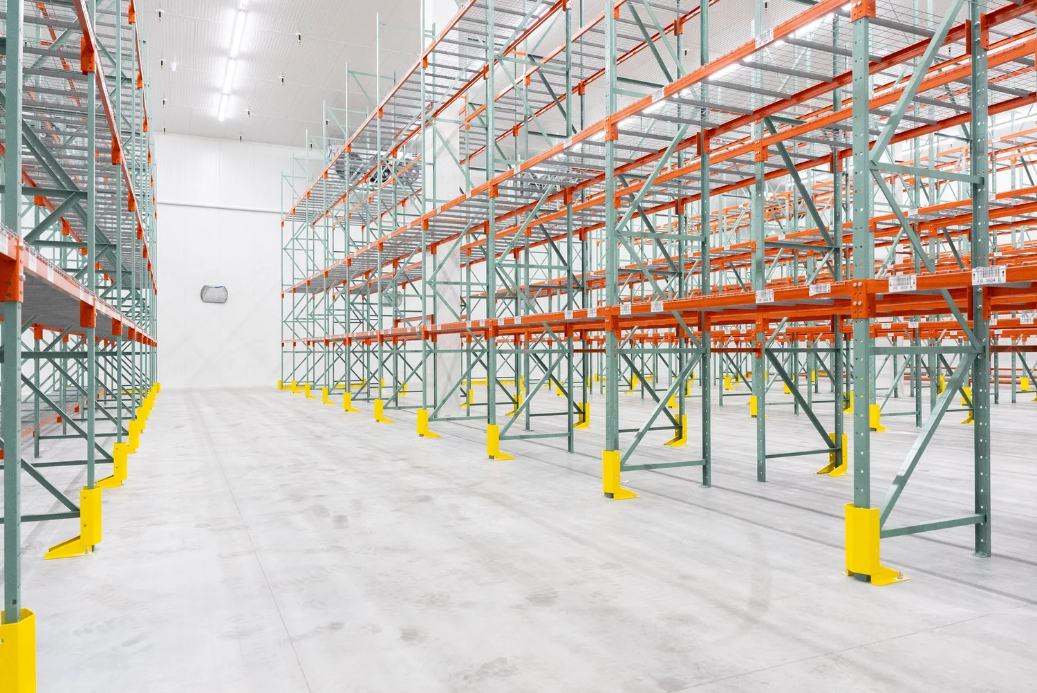 Long aisle of pallet racking inside a finished cold storage facility