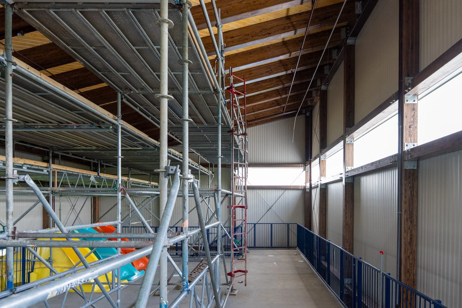 Interior scaffolding showing insulated metal panels fastened to the glulam timber frame of the Massanutten Water Park stair tower